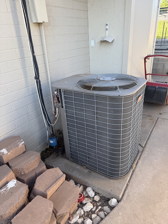 Rush HVAC technician performing same-day AC repair on a residential unit in the East Valley, AZ