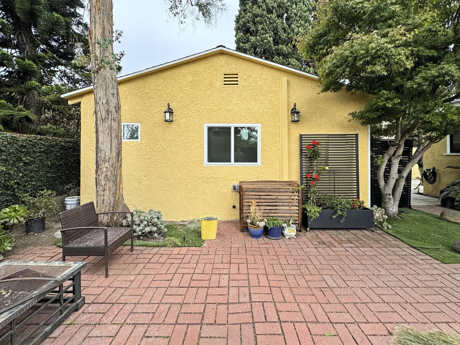Garage converted into an ADU by GreenTech in Culver City, with a brick patio