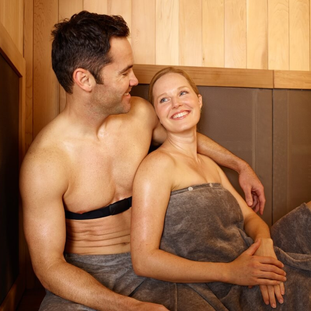 a couple cuddling and sweating on each other in an infrared sauna 