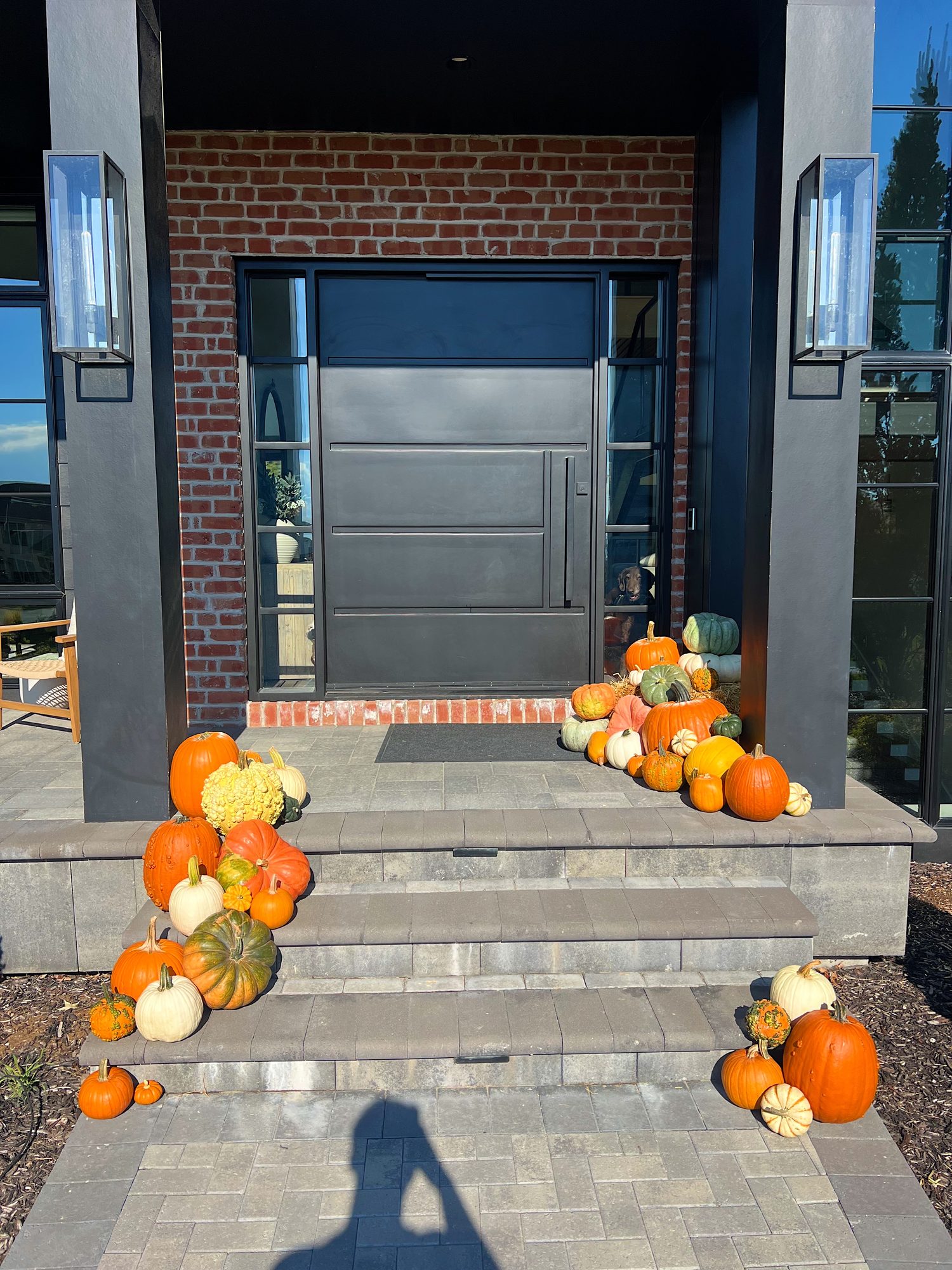 Abundant fall pumpkins cascading down front steps