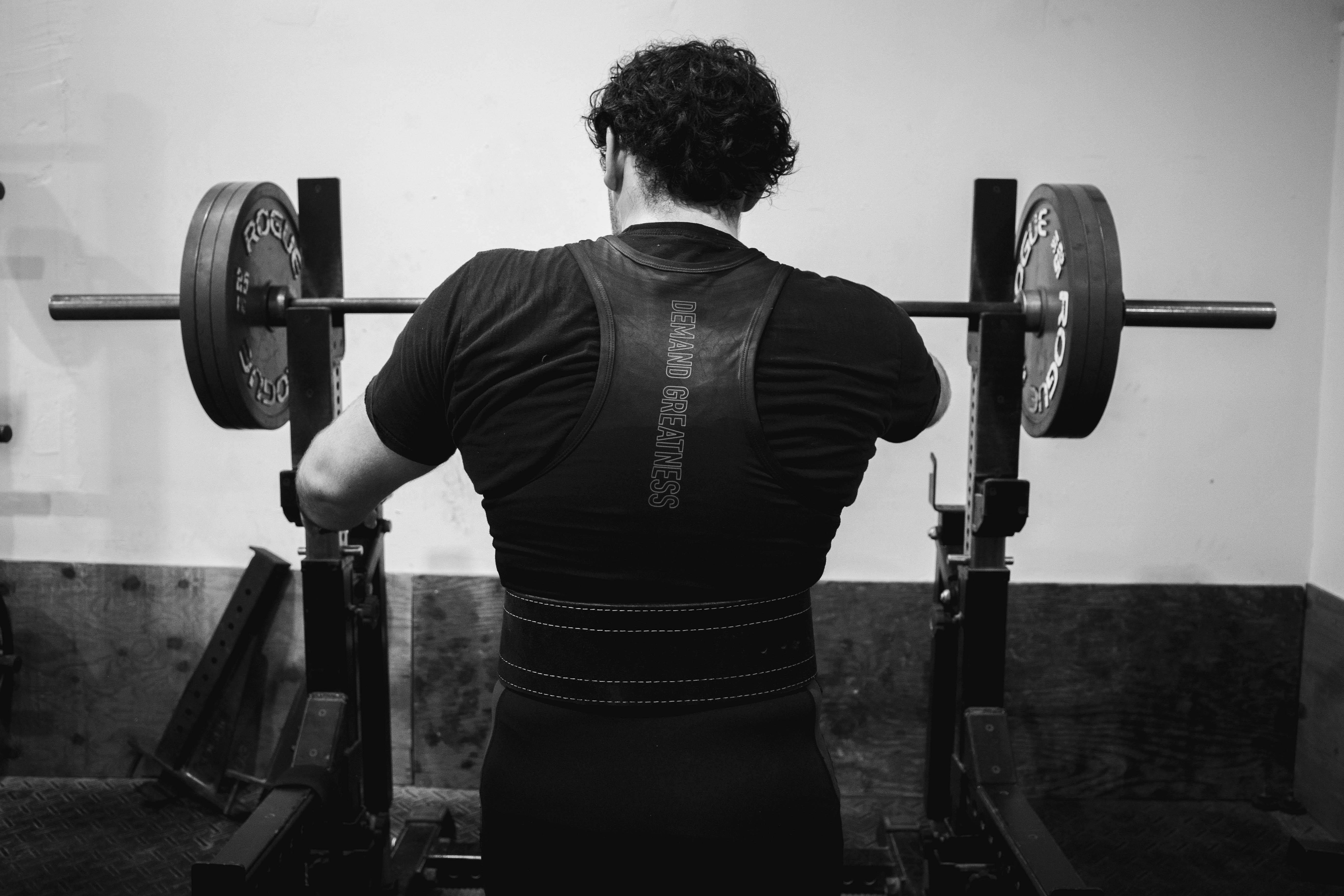 Team Soul members performing barbell strength training during a powerlifting session in Miami.  Powerlifting athletes training the squat, bench press, and deadlift at Team Soul Fort Lauderdale.