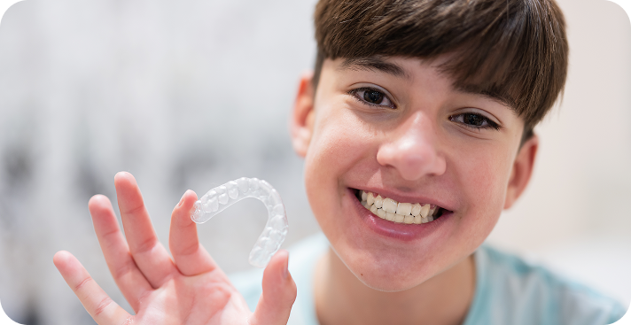 teen holding invisalign
