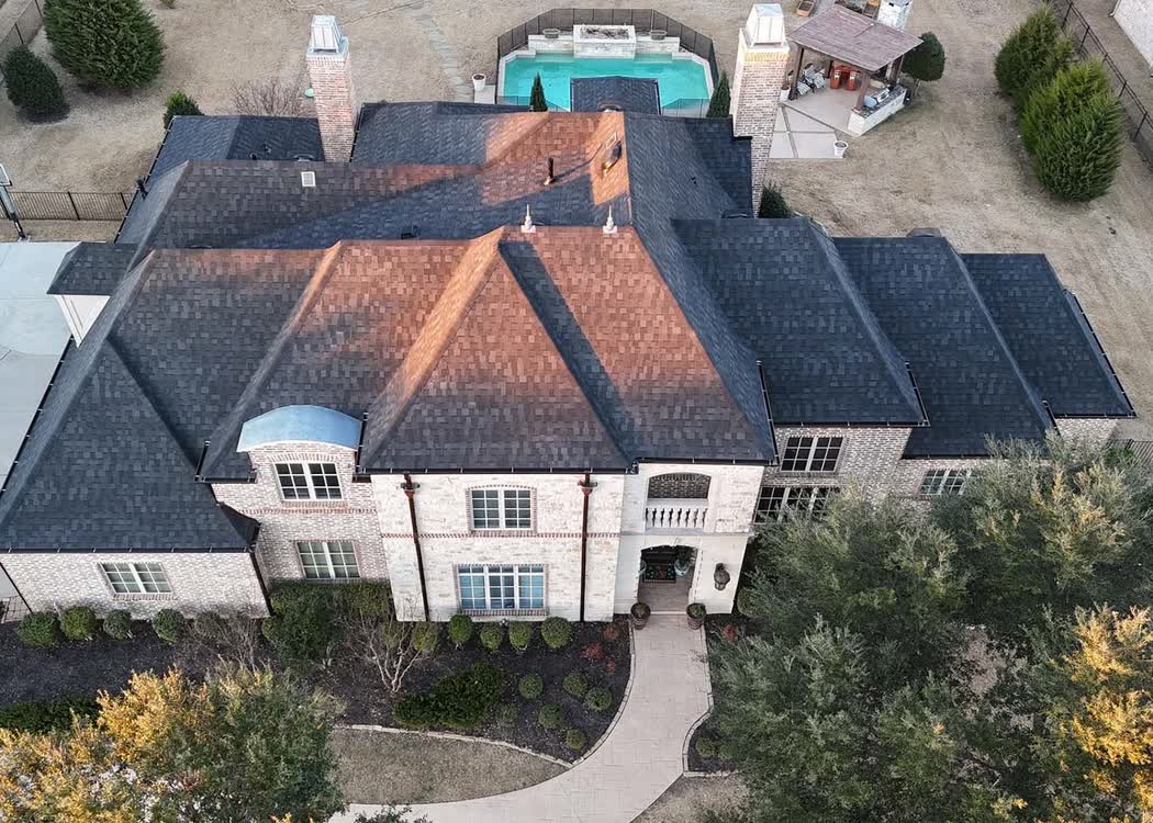 Aerial view of a finished roof on a brick home
