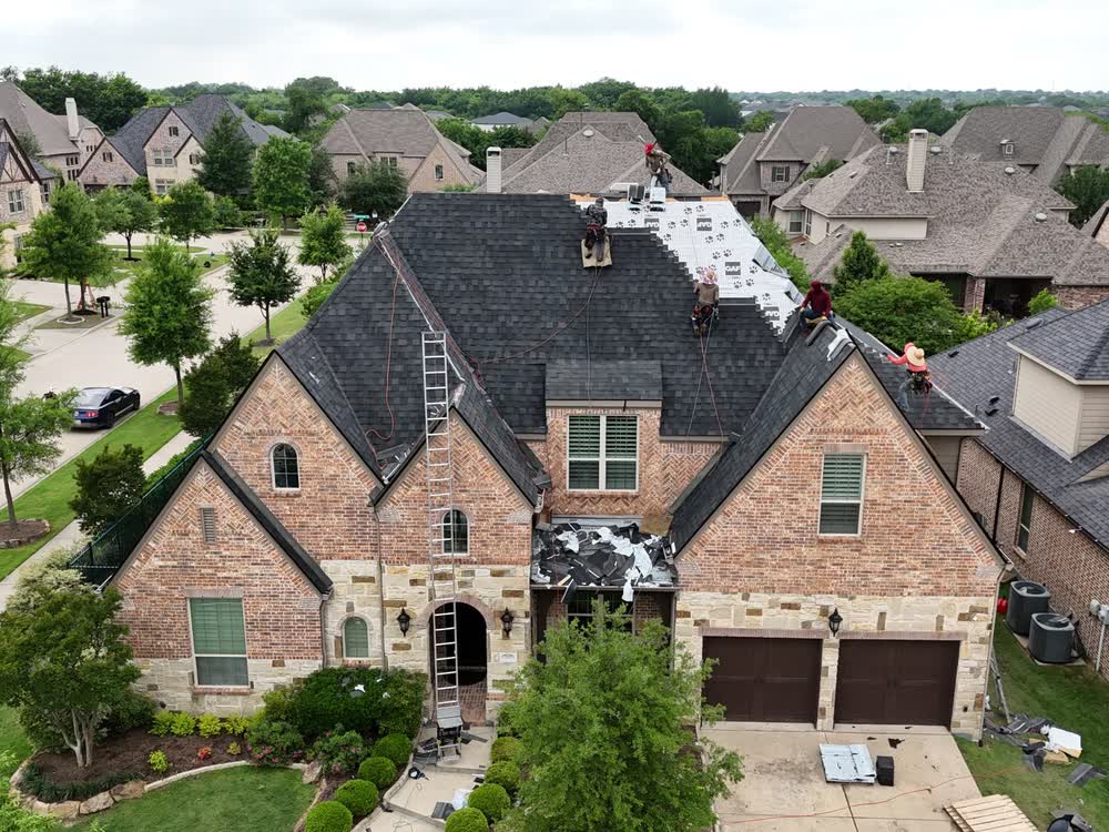 Aerial view of a roofing crew working on a home's roof