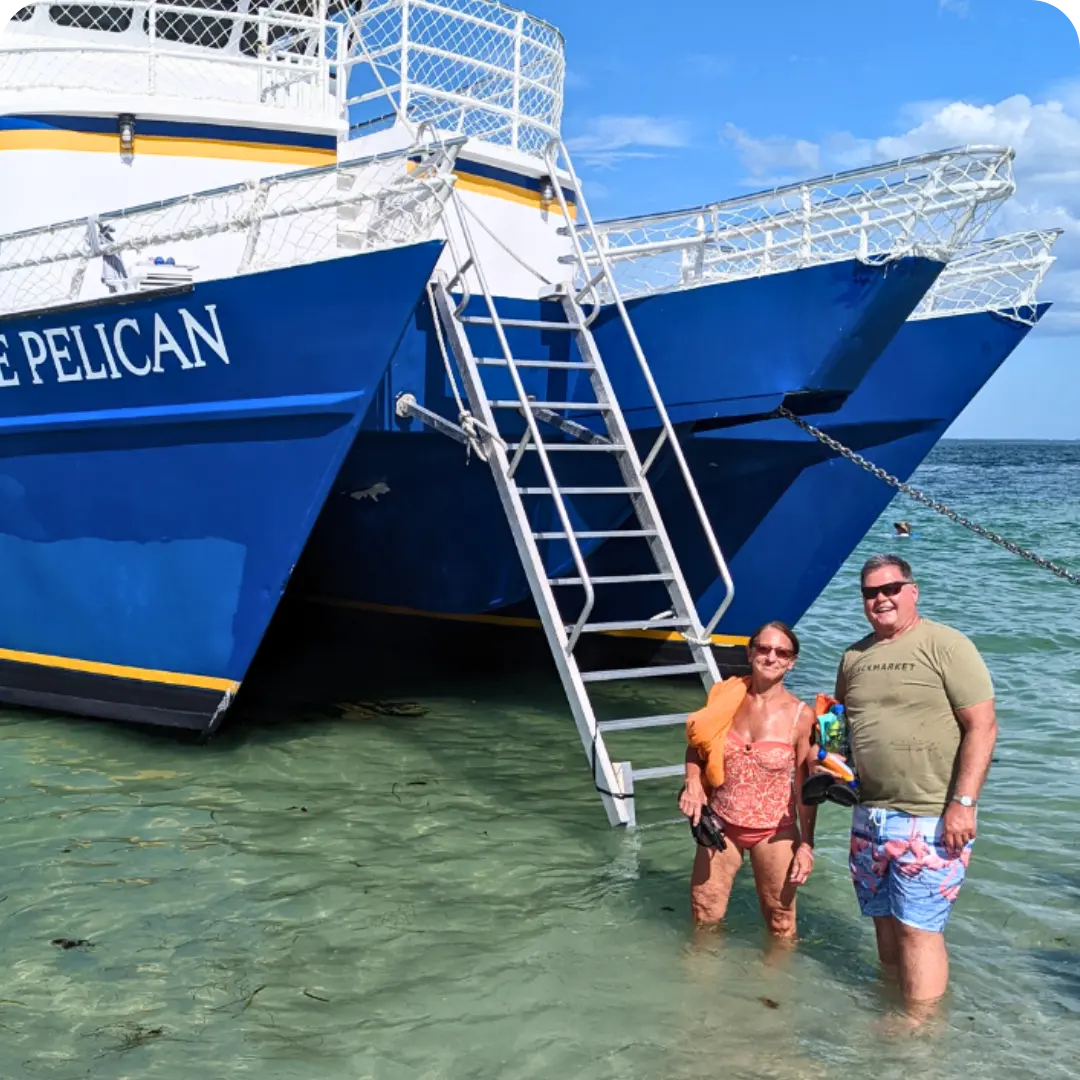 A couple standing in from of The Pelican St Pete after getting off the boat at Egmont Key