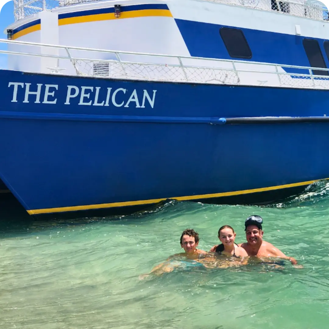 Family of three swimming in the water at Egmont Key after getting off The Pelican St Pete tour boat