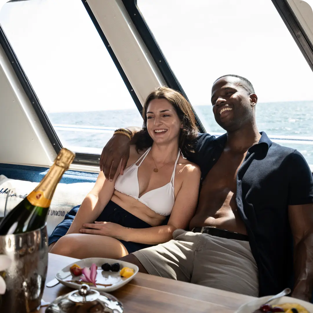 A couple relaxing indoors on The Pelican St Pete boat