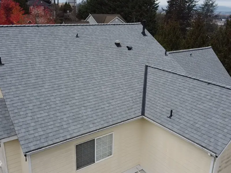 Close-up aerial view of a newly shingled roof by a roofing contractor.