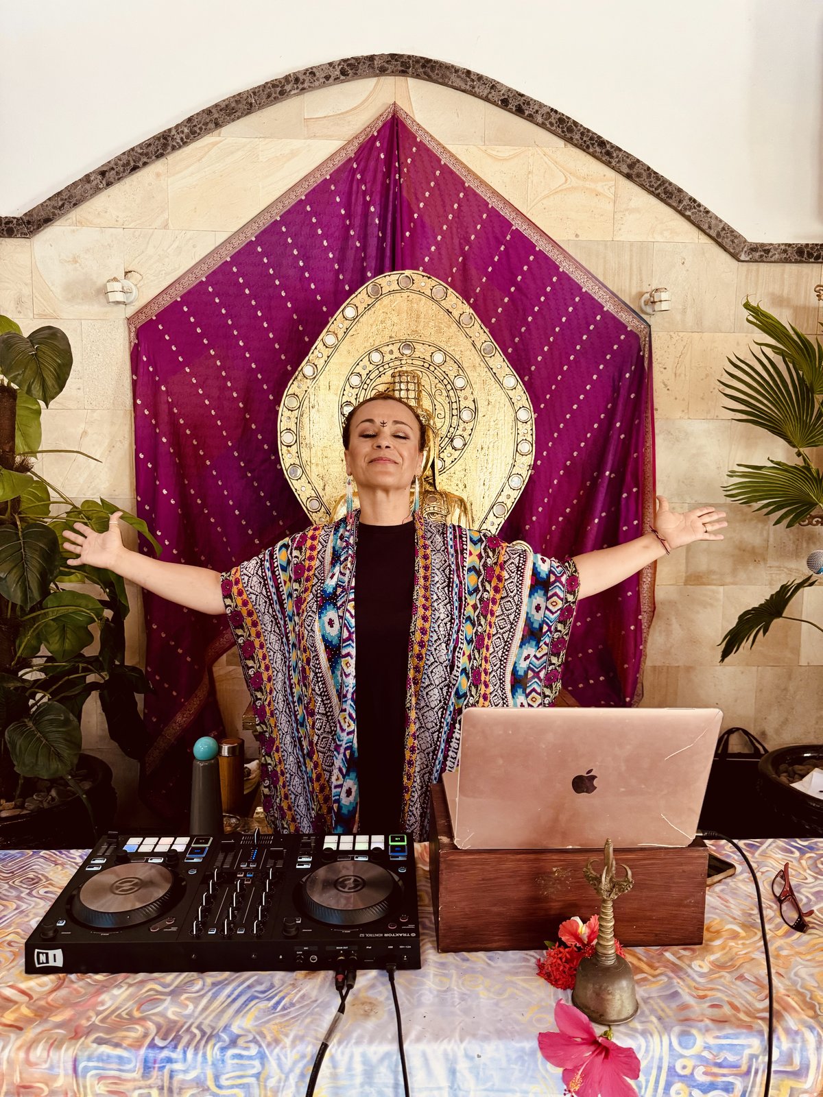 Farah performing in a decorative headdress at the DJ booth