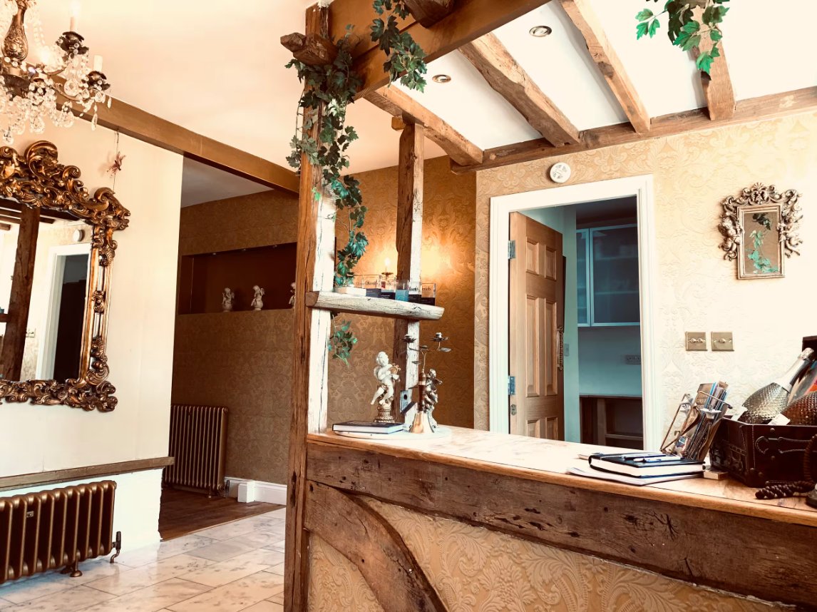 A characterful hallway with exposed wood beams and vintage decor