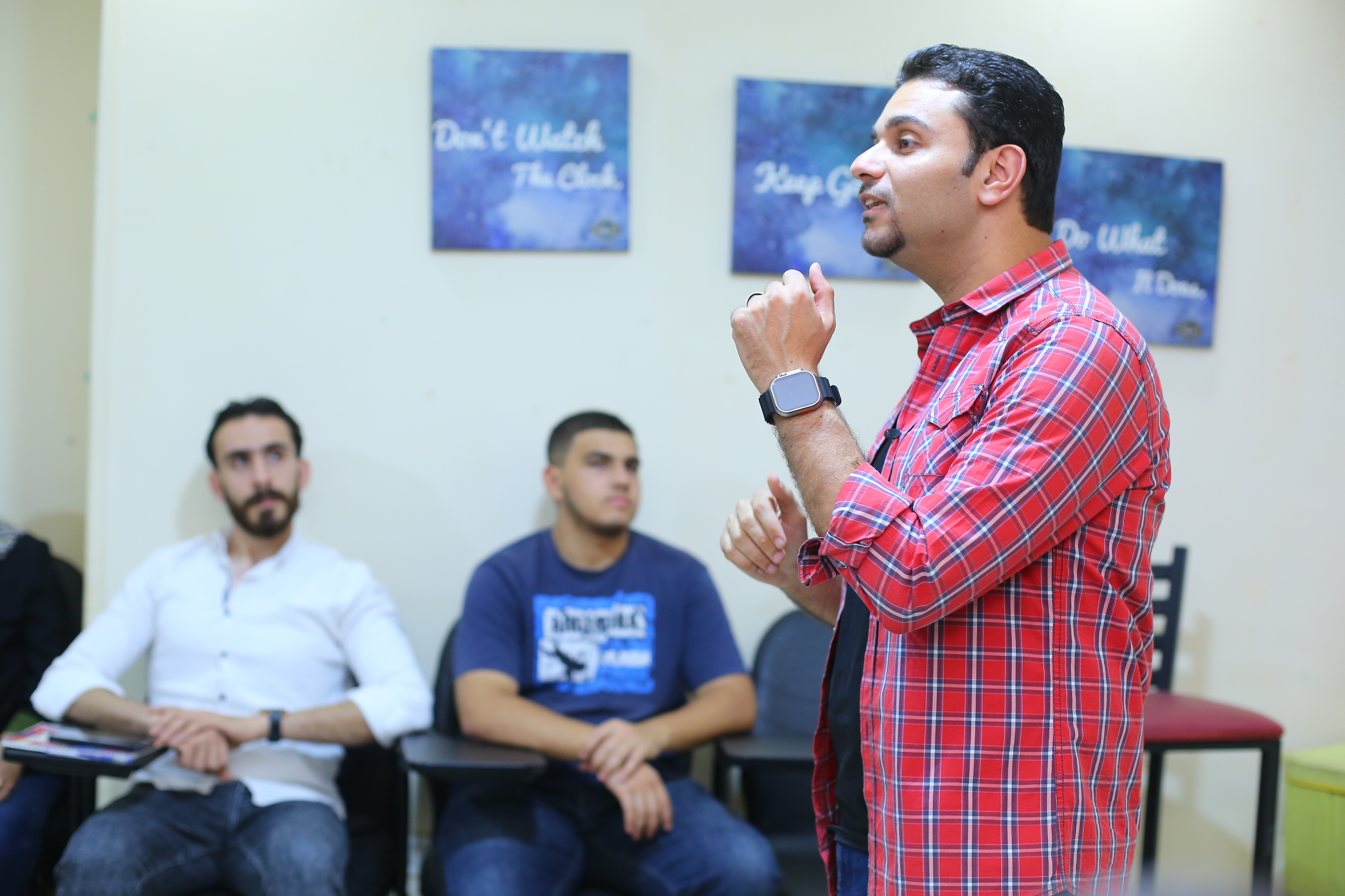 NLP graduates celebrating with certificates in a live training session at Ahmed Latif Academy