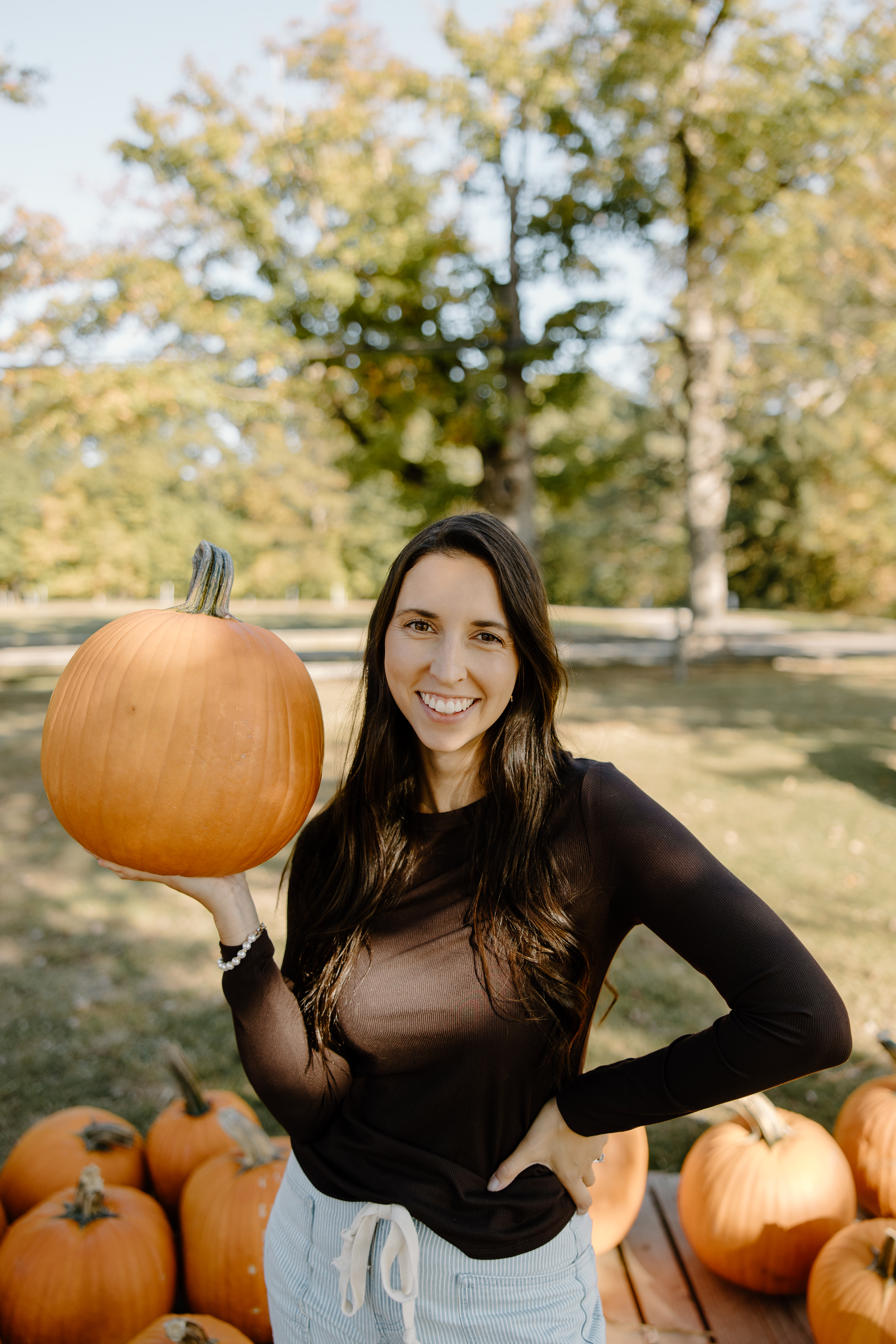 The Local Pumpkin founder holding a fresh pumpkin at a Geauga County pumpkin patch