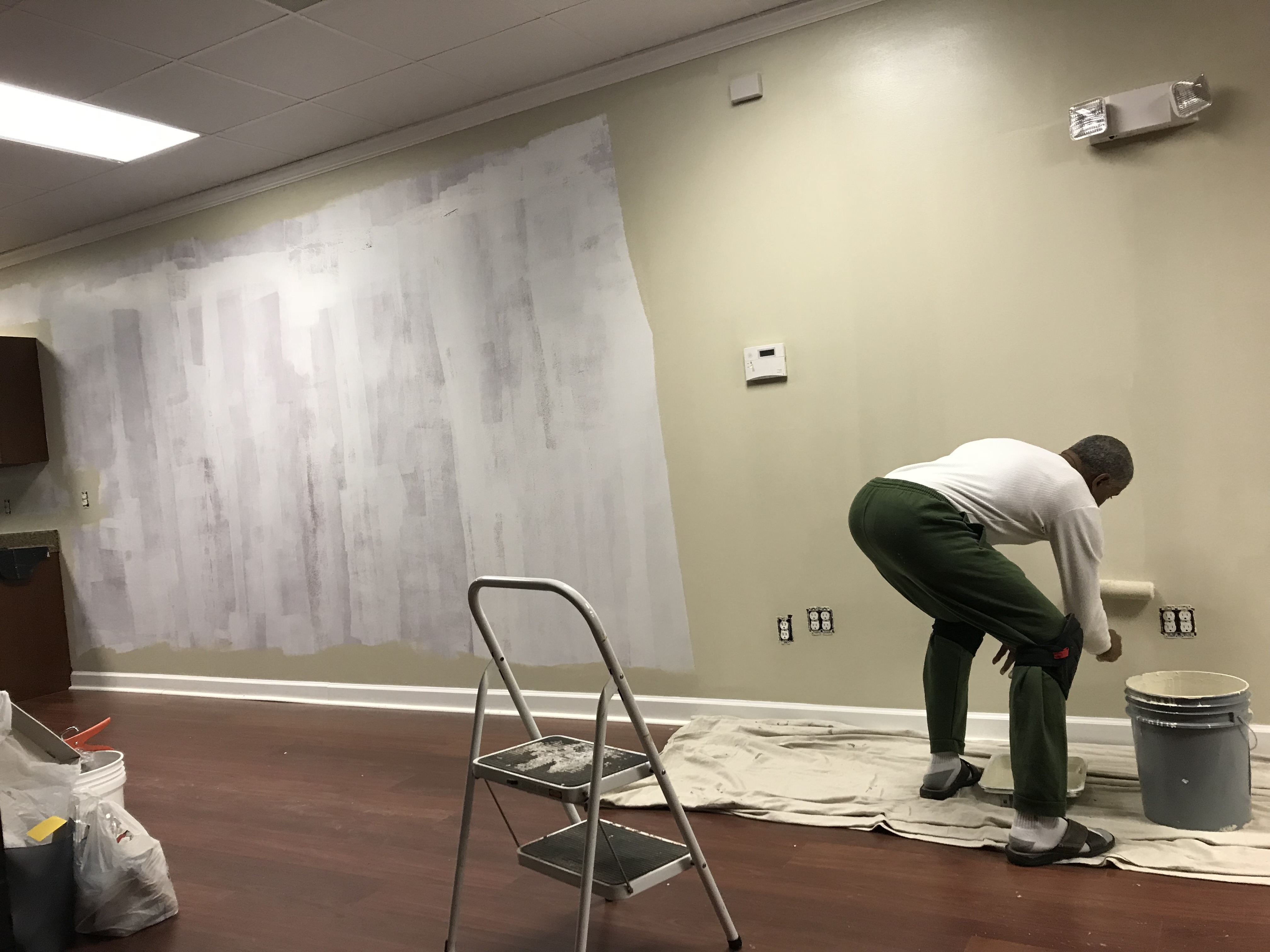 Andre Horne painting the commercial space during the medical practice renovation