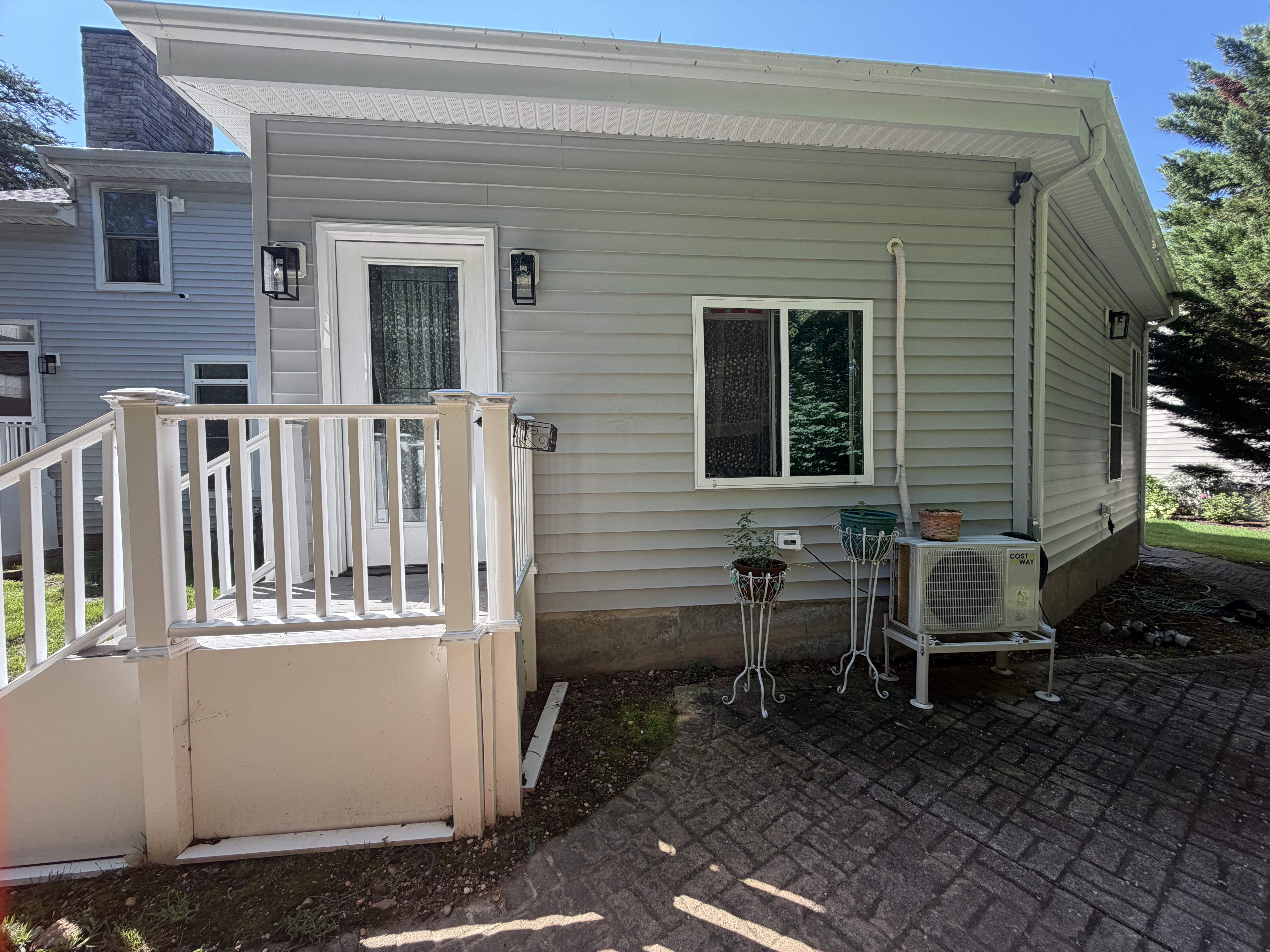Completed mother-in-law suite exterior and private entry built from the former backyard deck area