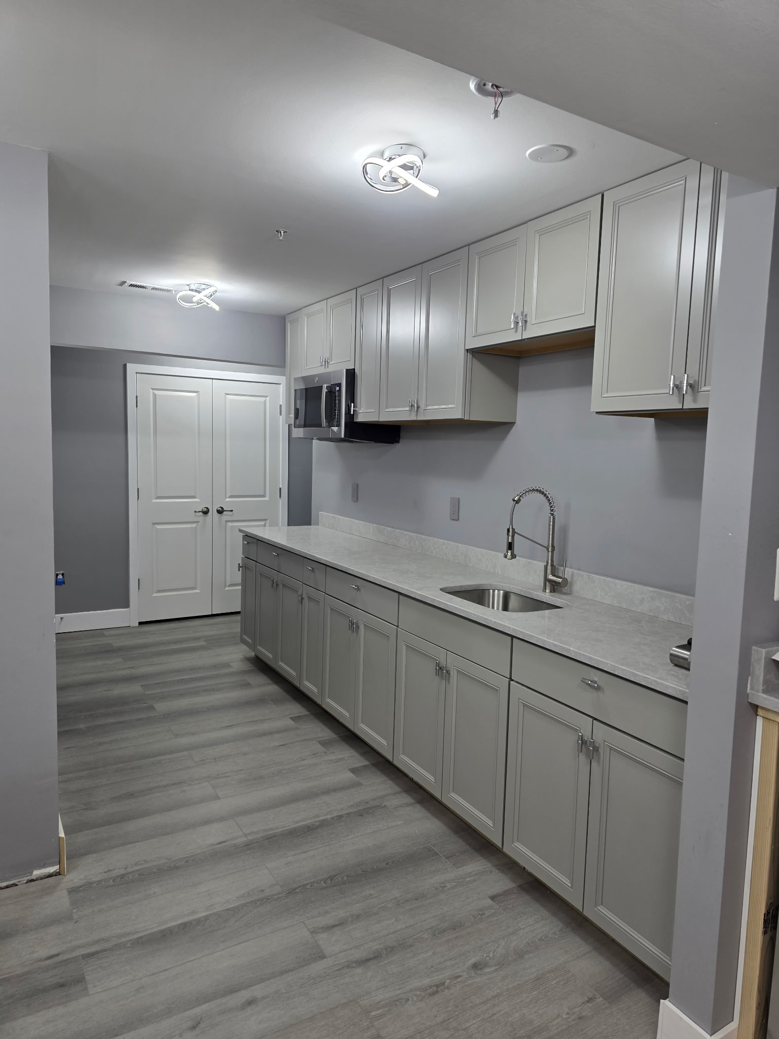 Additional view of the basement kitchenette by Andre Horne