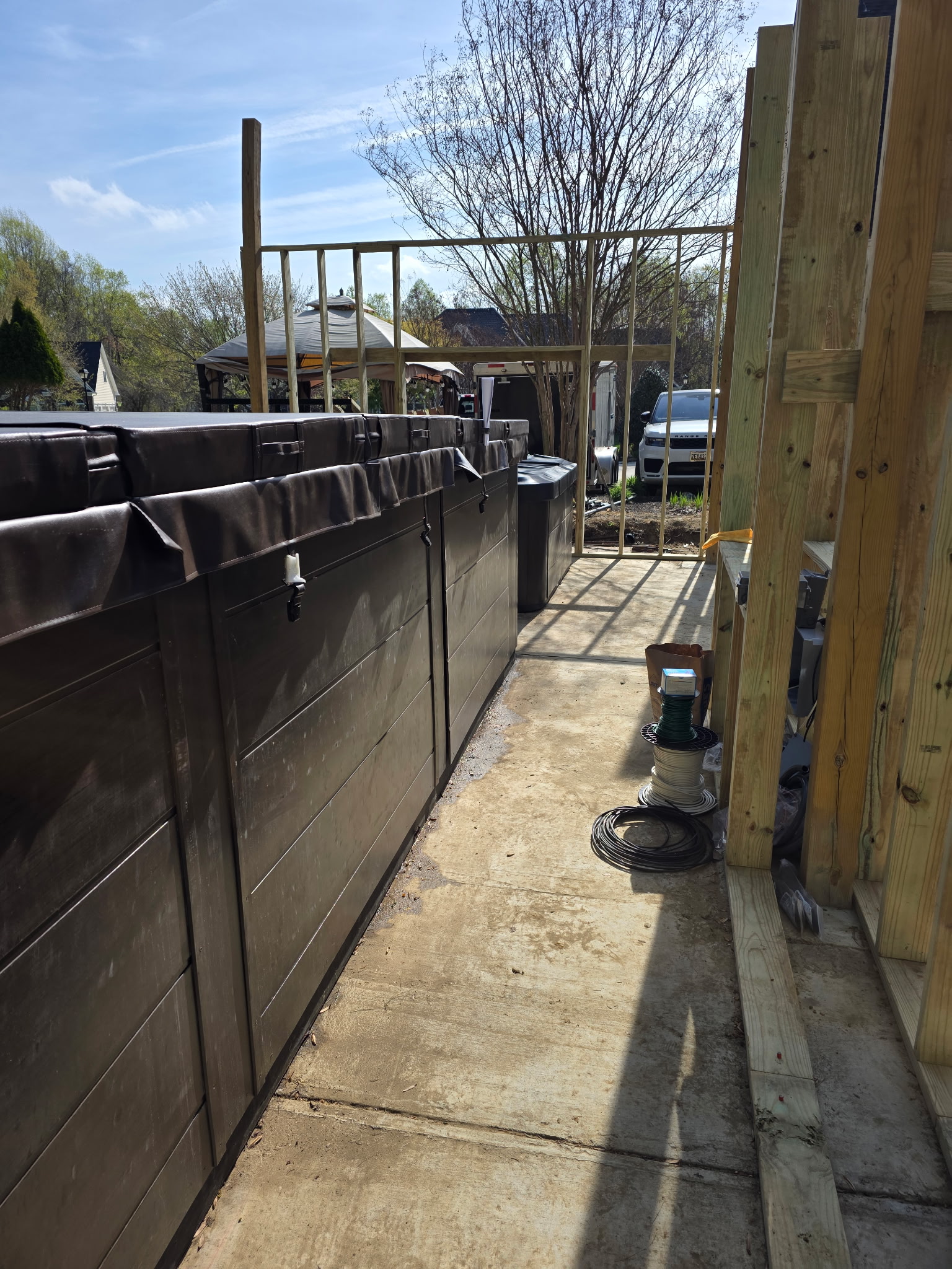 Framing under construction around an outdoor whirlpool spa