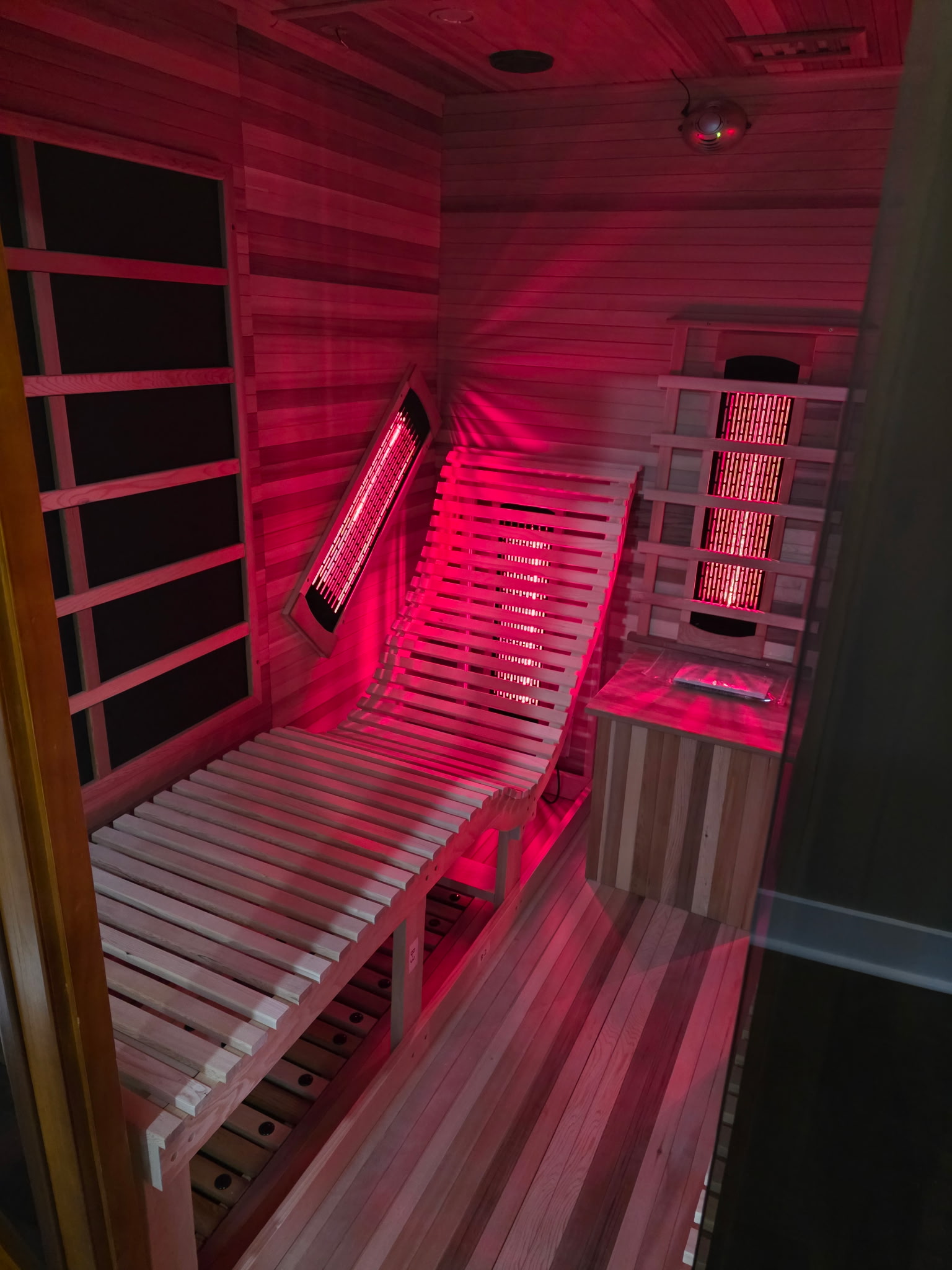 Interior of sauna with infrared lighting and reclining bench