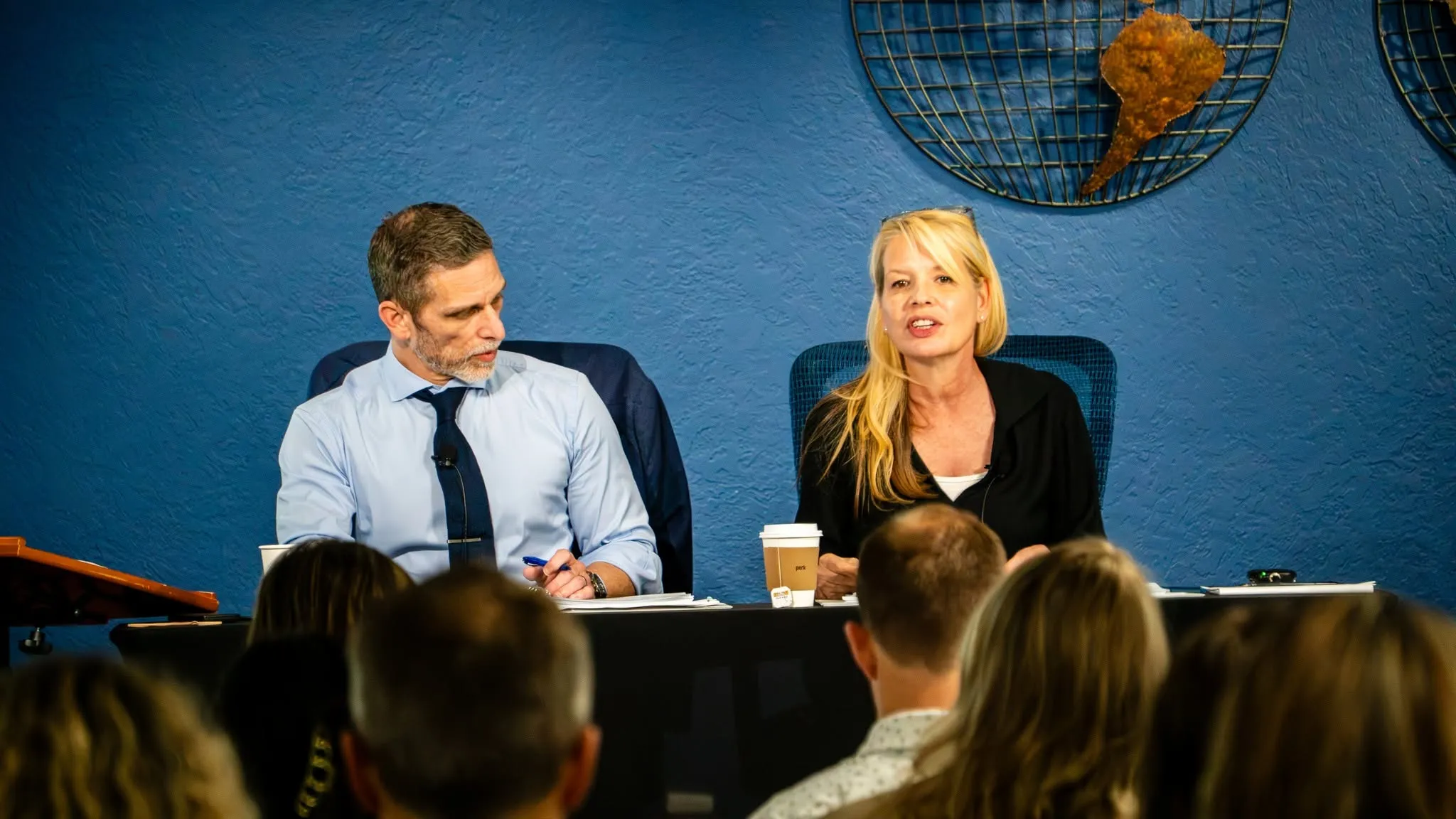 The two presenters answering questions from seminar attendees seated in front of them