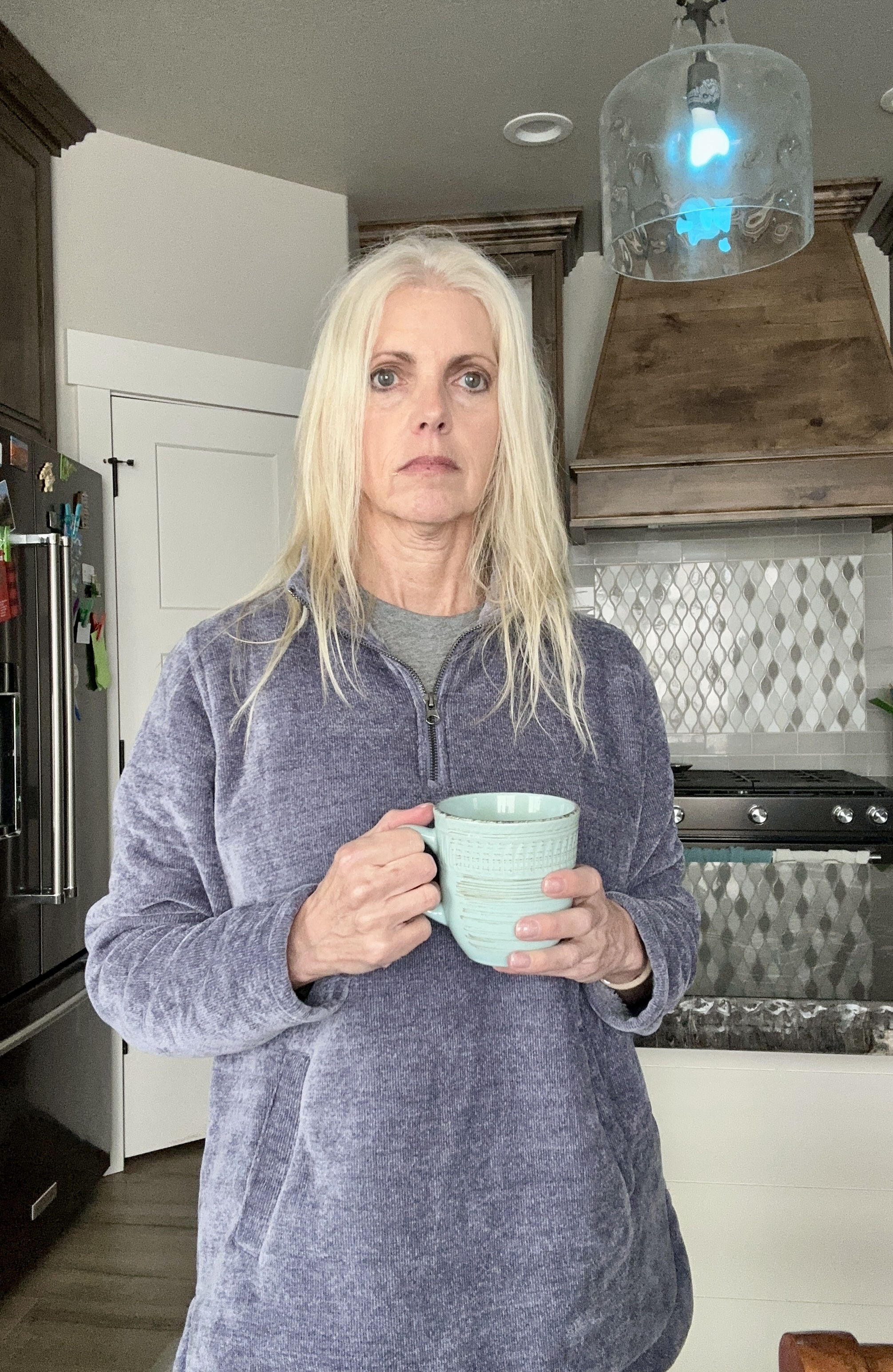 Woman observing interaction with coffee in a office kitchen