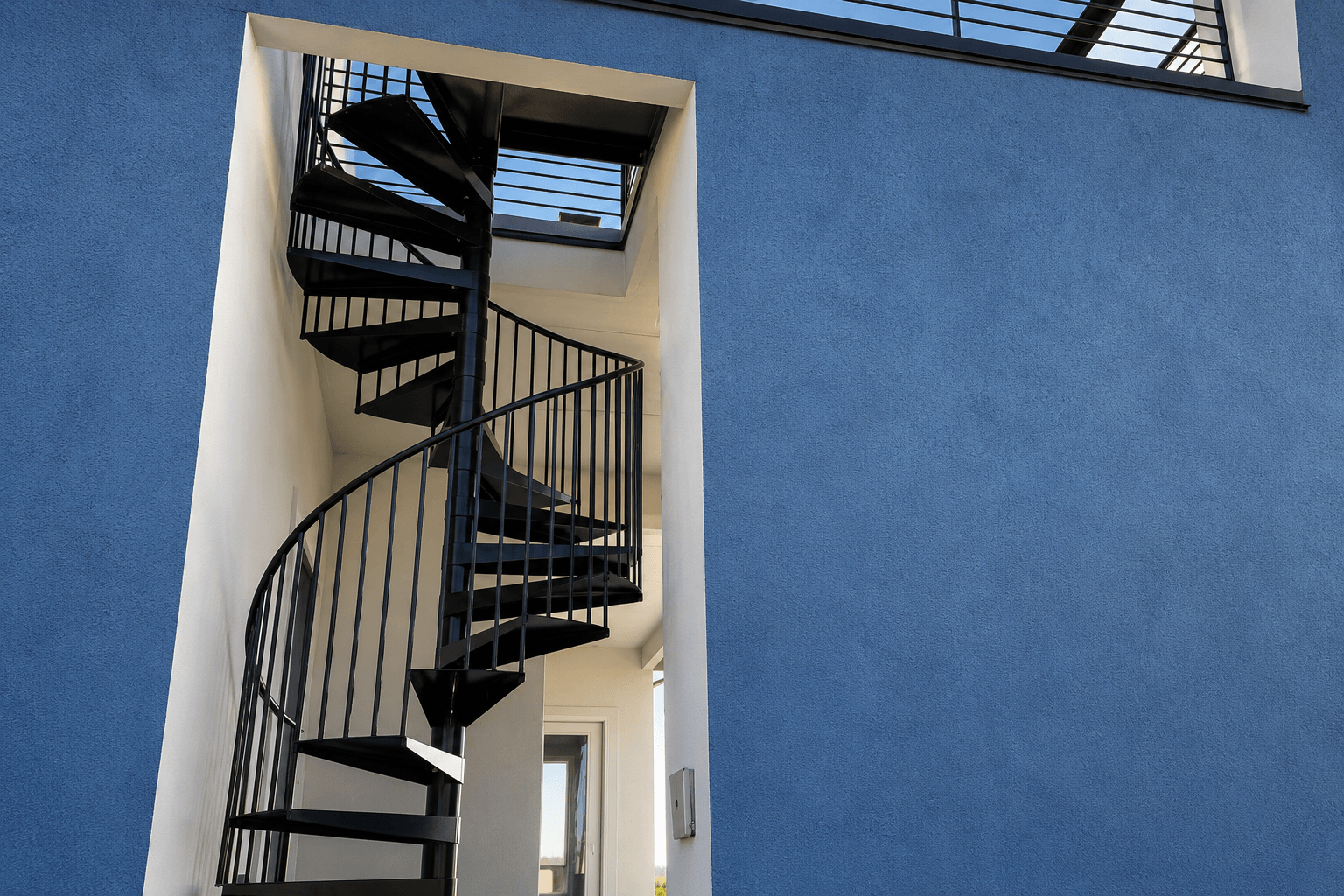 Custom iron spiral staircase fabricated by Kodiak Gates & Iron in Eagle, Idaho.
