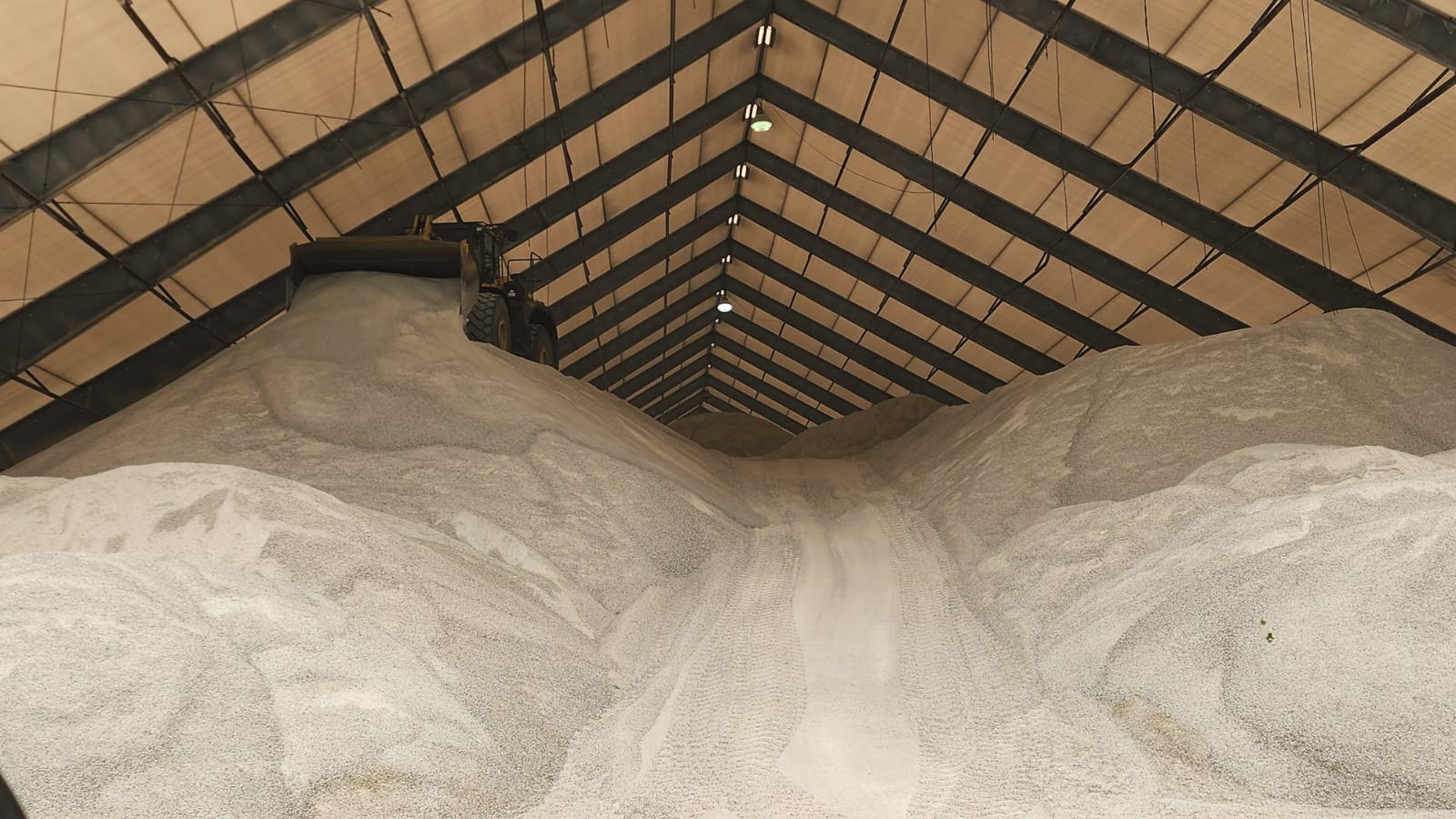 Rock salt stockpiled inside a covered storage building