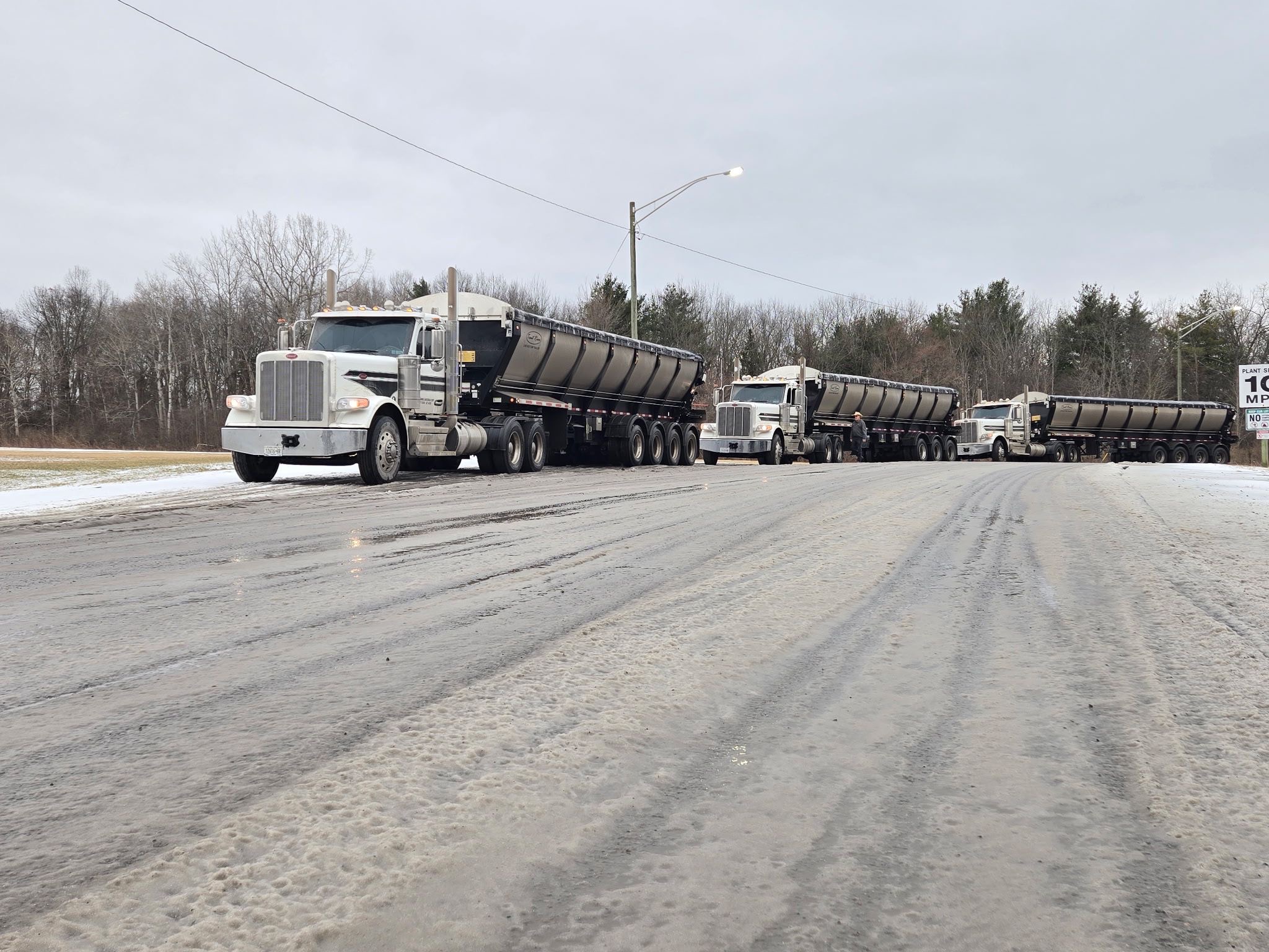 Bulk salt trailers lined up on a winter road