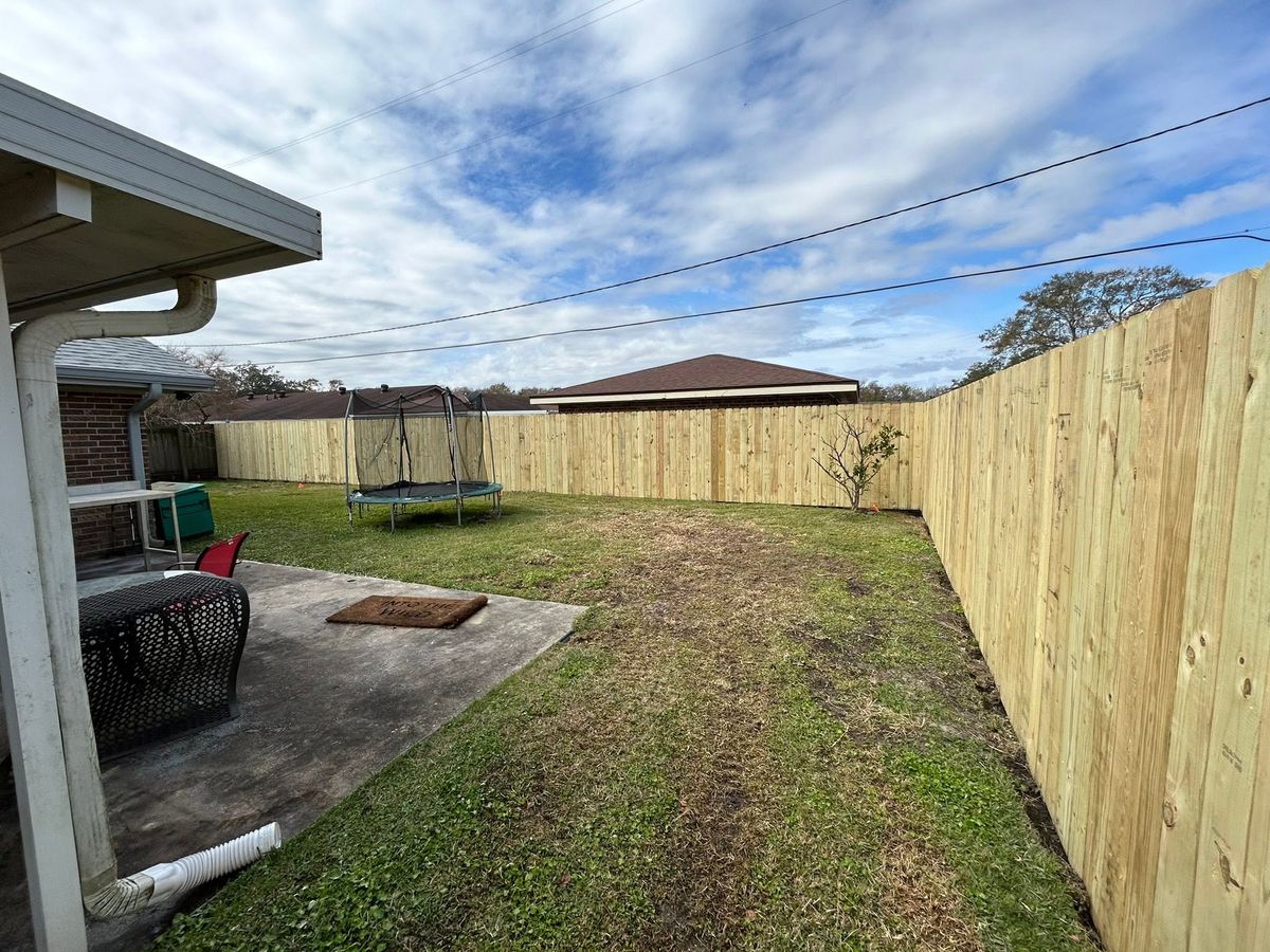 New wood privacy fence enclosing a residential backyard