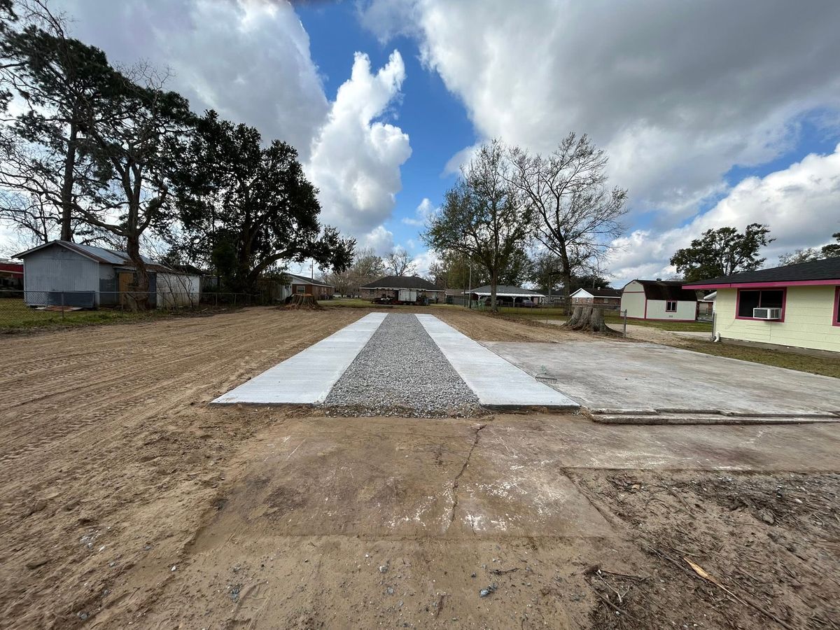 Newly poured concrete driveway with a gravel center strip