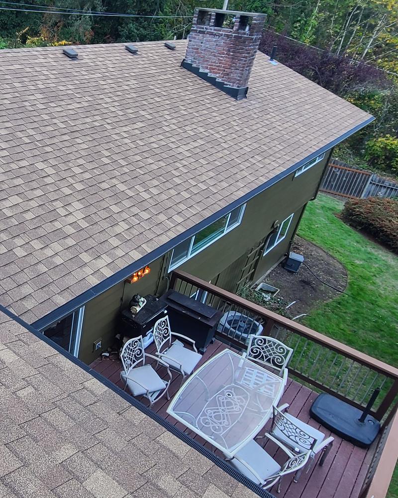 Finished rear roofline with Raindrop gutter guards over a deck