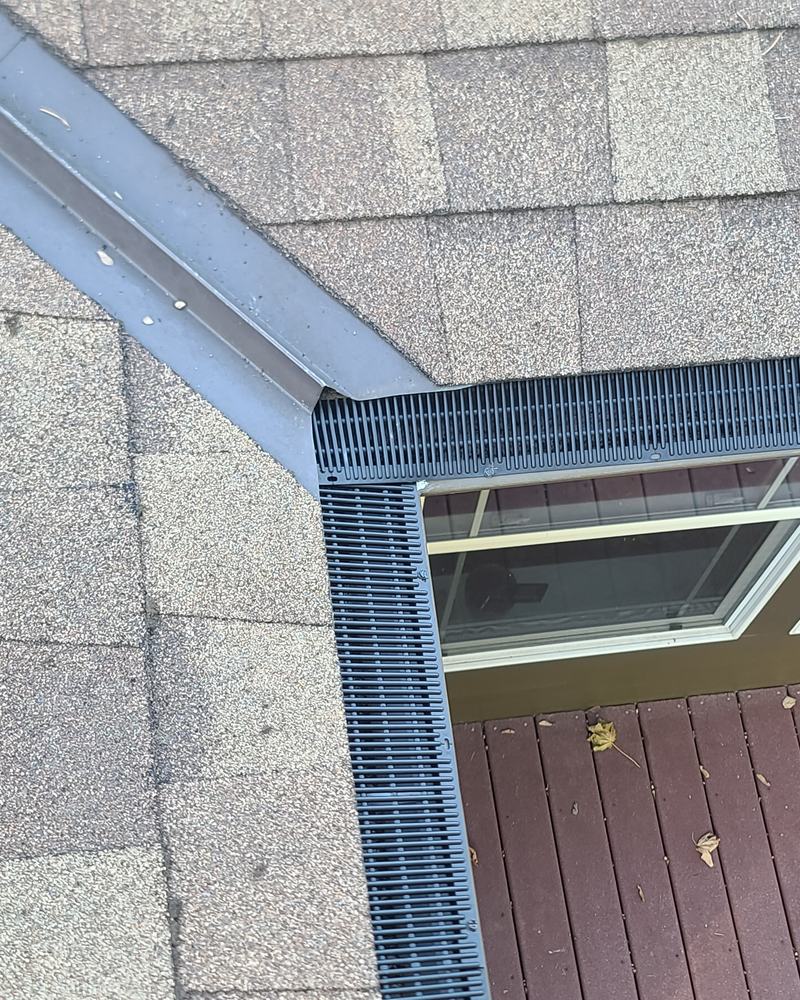 Raindrop gutter guard meeting at an inside corner above deck windows