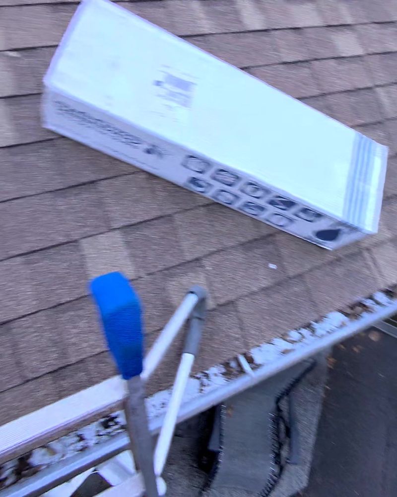 Blower and supplies on a roof during gutter prep