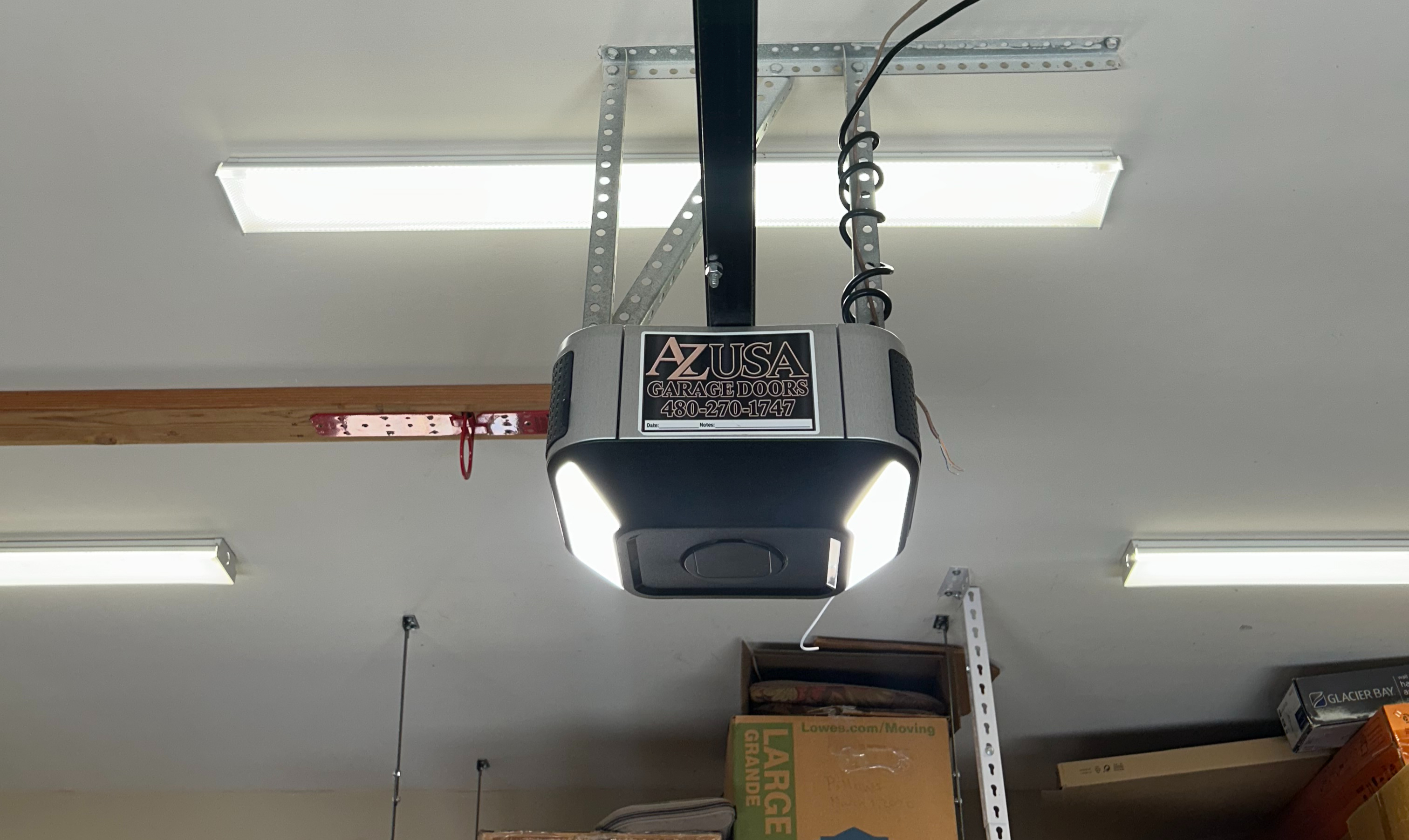 Garage door opener motor and drive unit being serviced on a residential door in Mesa Arizona