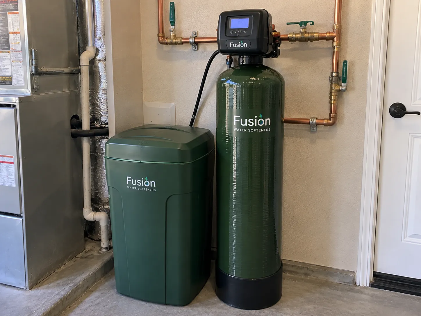 Fusion whole-house water softener system installed beside a residential HVAC unit