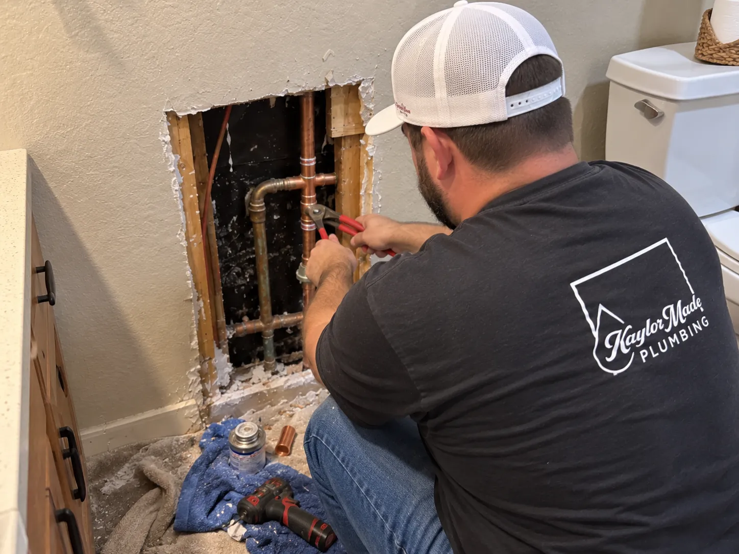 an image of Kaylor fixing a burst pipe