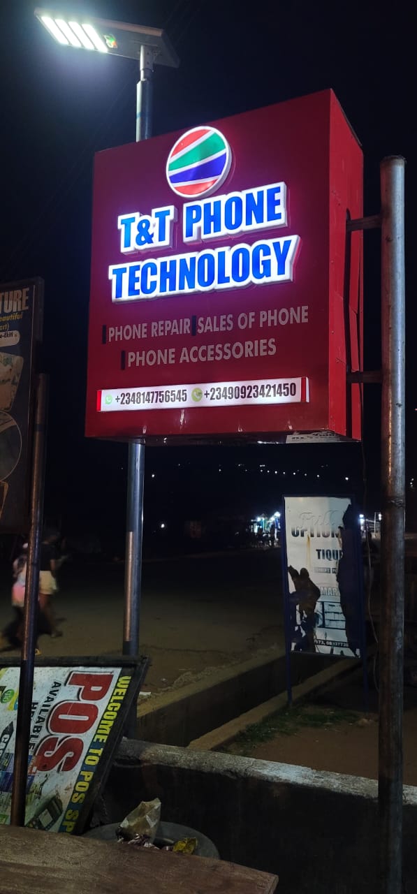 T&T Phone Technology storefront signage at night