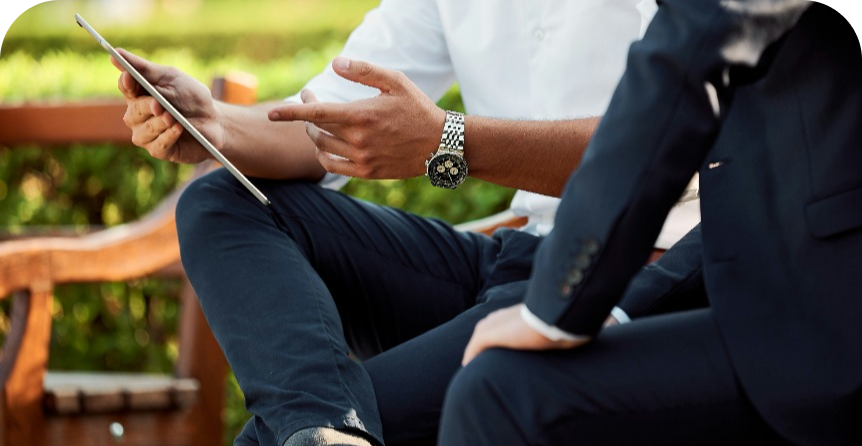 Accountant discussing wealth management with client, sitting outside 