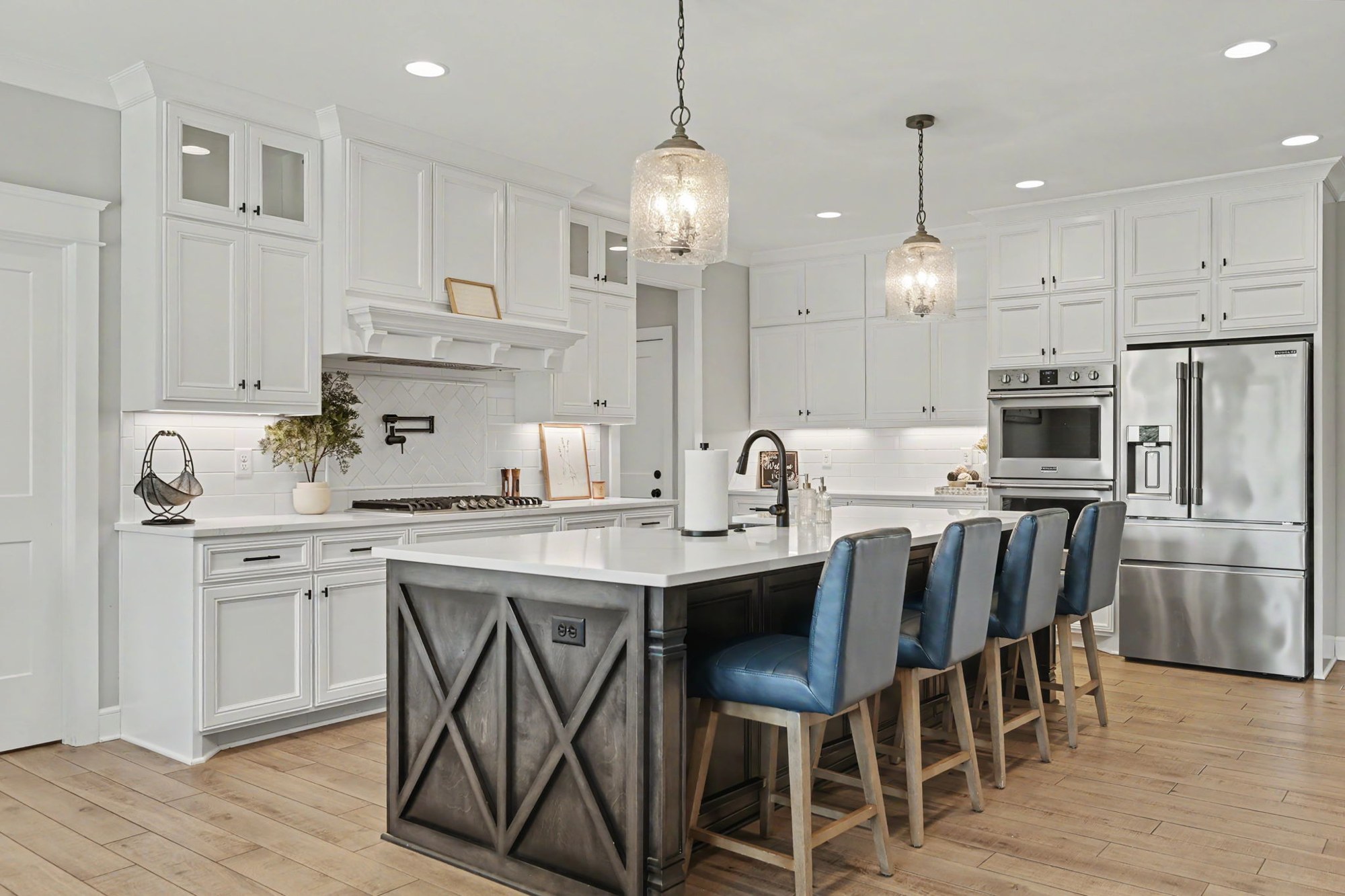 Bright white kitchen with an island and blue chairs