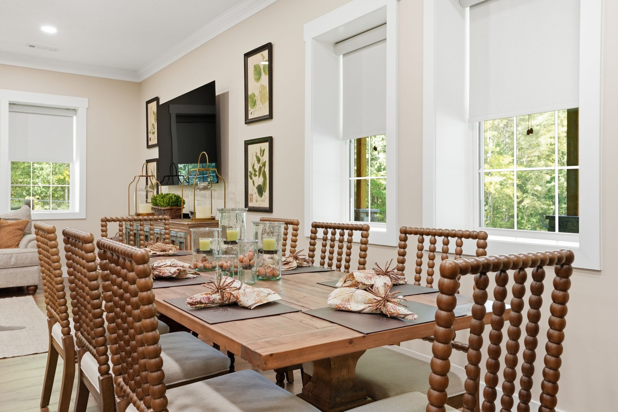 Sunlit dining room with a set table and tall windows