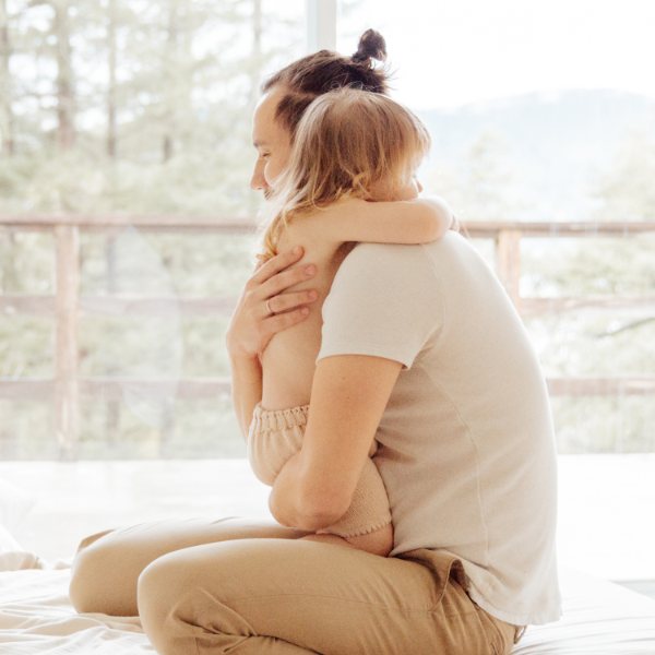 Parent hugging their toddler