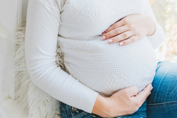 Pregnant woman holding her belly