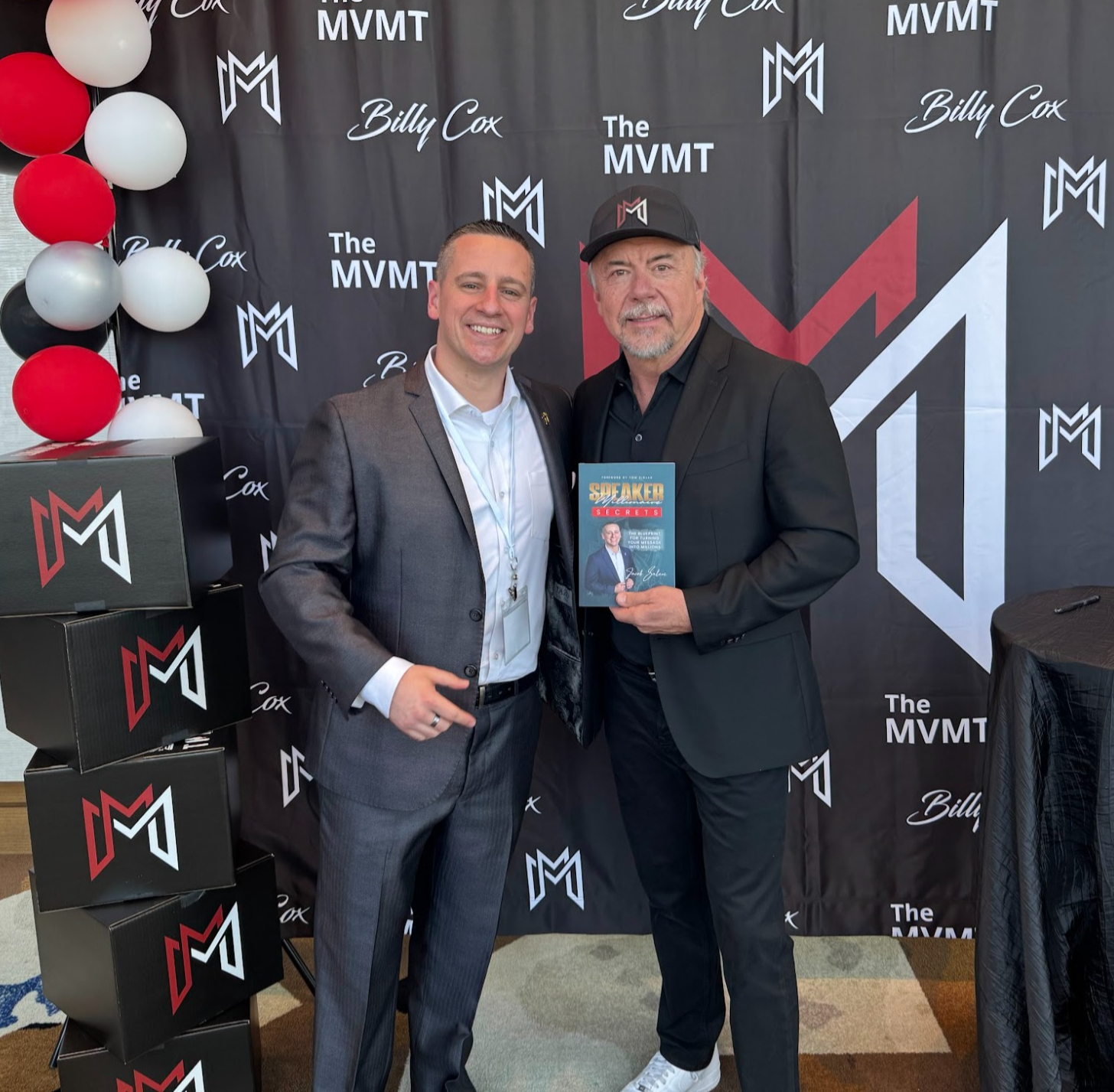 Billy Cox holding Speaker Millionaire Secrets with Jacob Salem