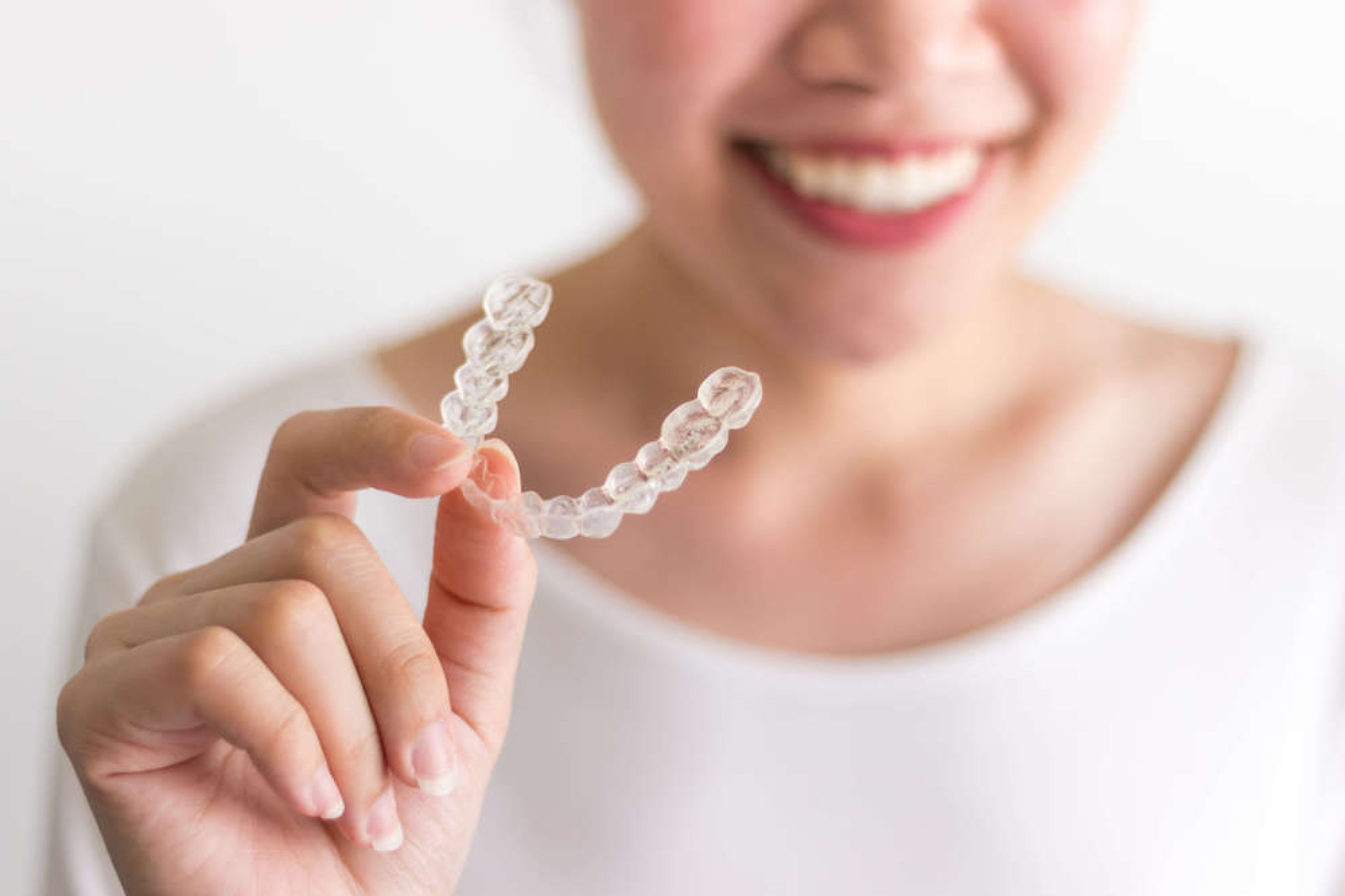 Woman holding invisalign
