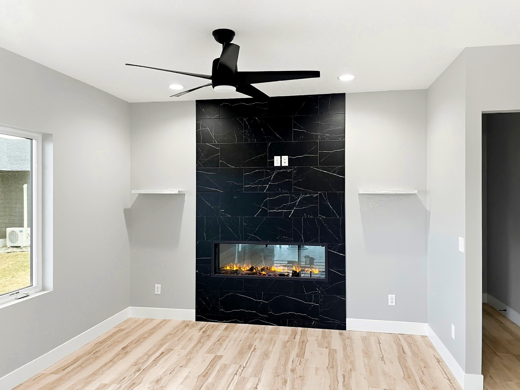 Finished living room with fireplace in a custom home in Siouxland