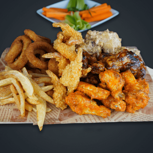 Big tray 10 crispy onion rings, 10 breaded shrimp, savory sausage slices, and golden French fries, accompanied by ranch, mango habanero, and onion dips. Served with refreshing celery and carrot sticks
