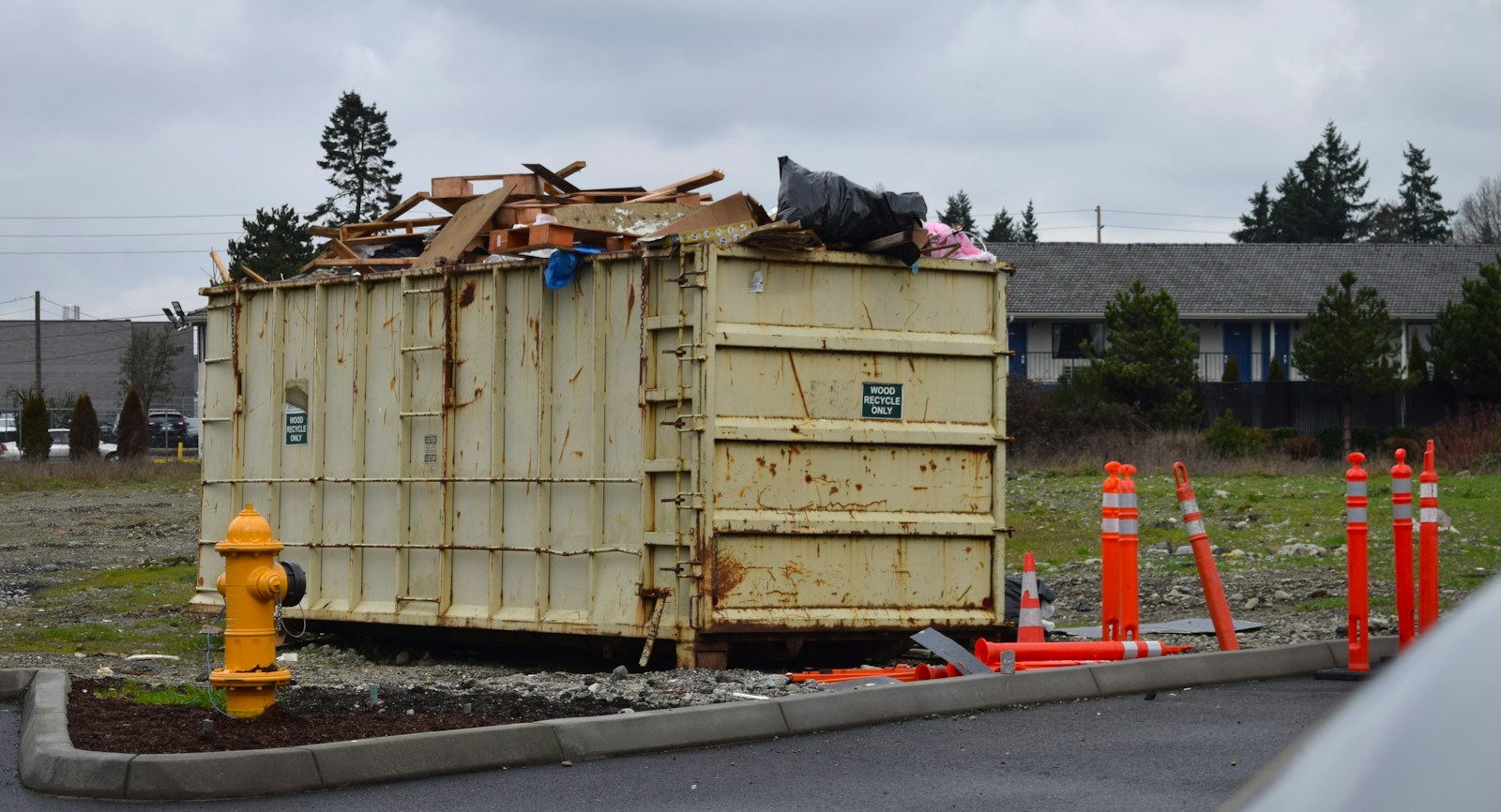 Large roll-off dumpster loaded with construction debris