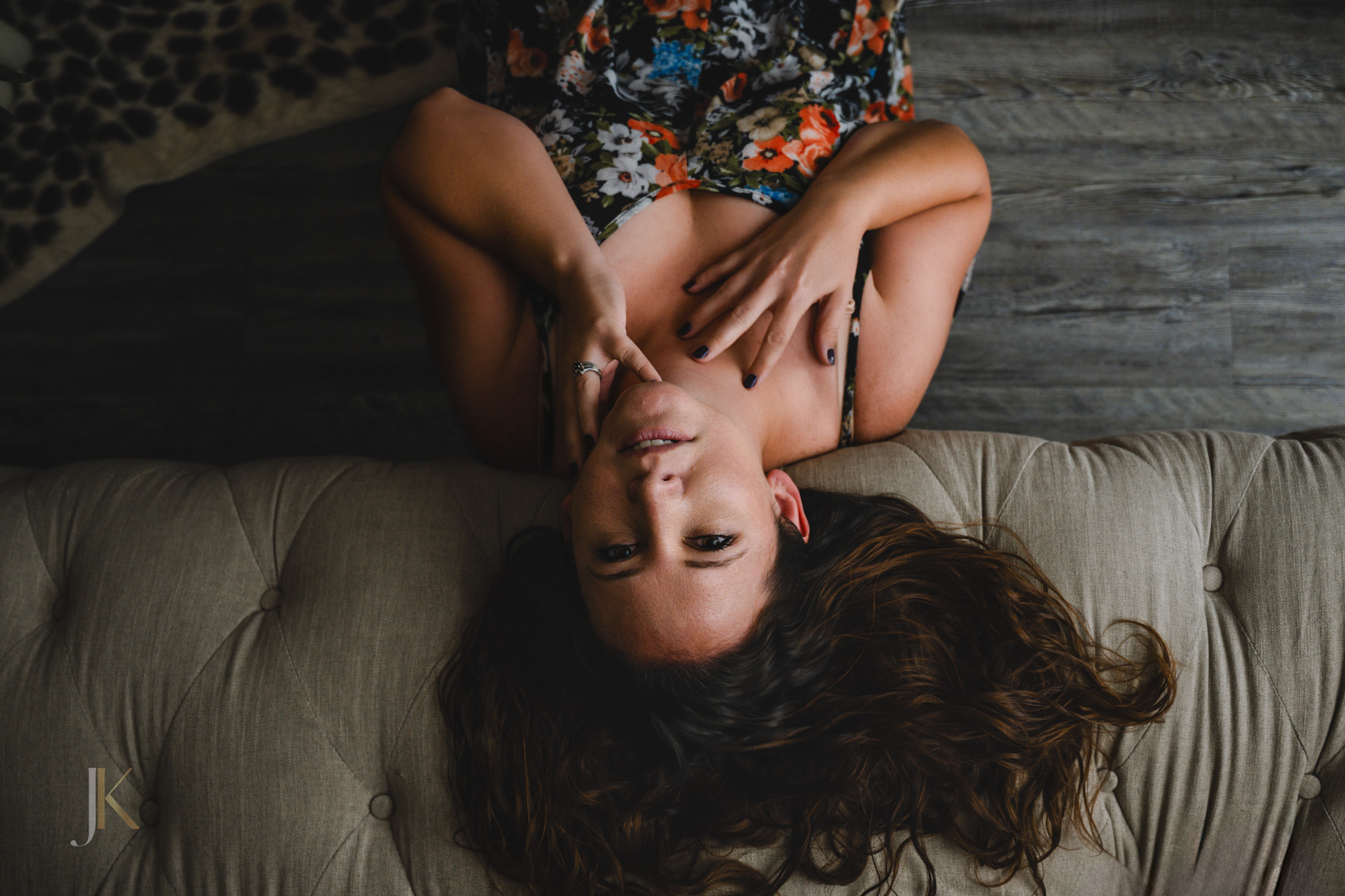 Moody boudoir portrait of a woman lying upside down on a couch in a floral bodysuit with soft shadows and intimate styling | Jessica Korff Studios Tucson, AZ Moody boudoir portrait of a woman lying upside down on a couch in a floral bodysuit with soft shadows and intimate styling | Jessica Korff Studios Tucson, AZ