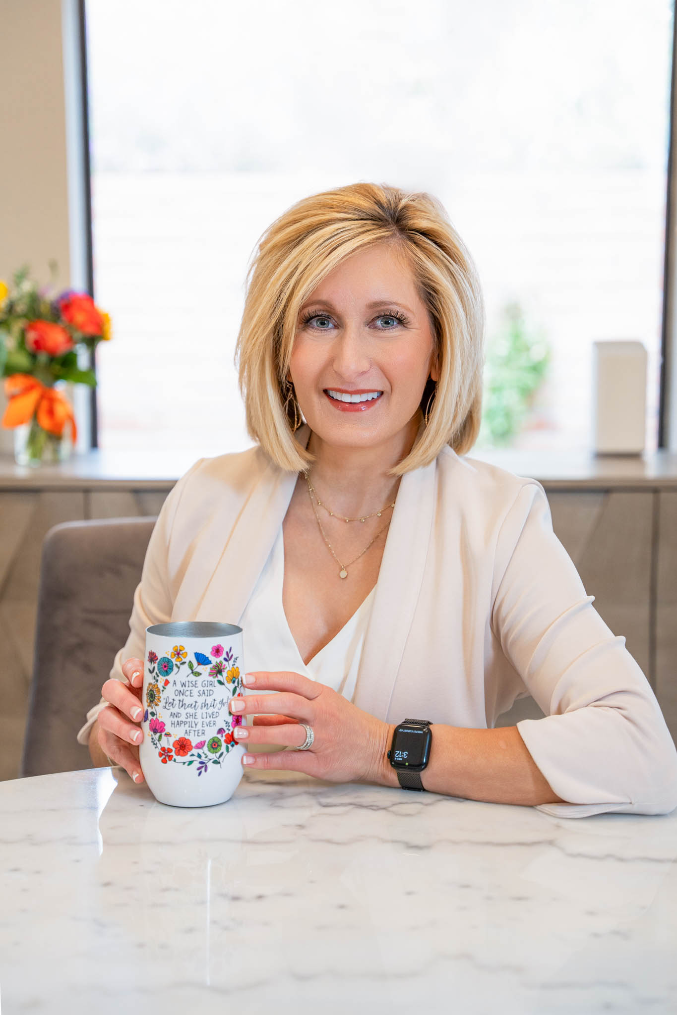 Professional branding portrait of confident business woman holding coffee mug at desk in modern office, Tucson Arizona personal branding photography | Jessica Korff Studios Tucson, AZ