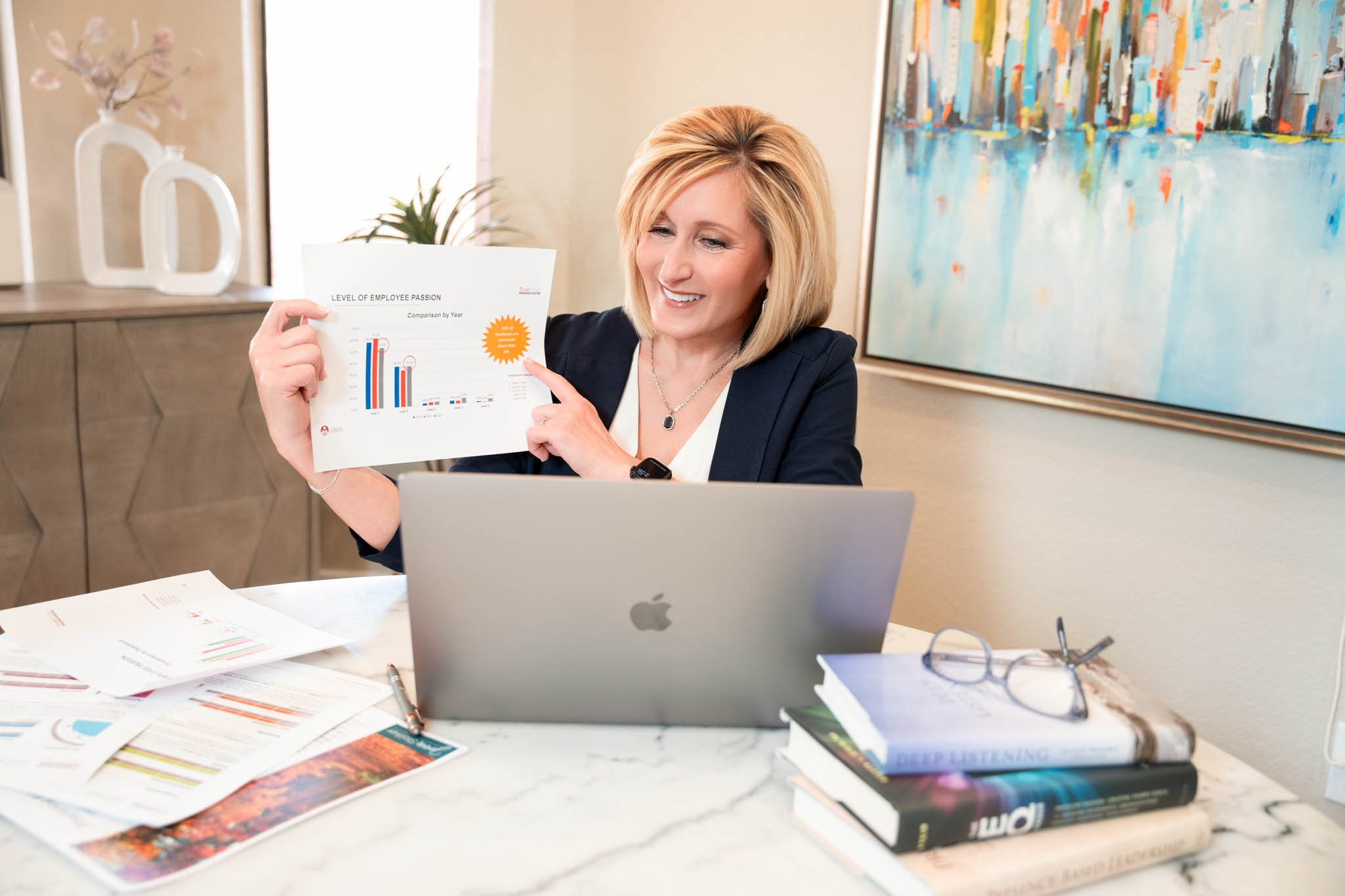 Business owner presenting analytics report at laptop during professional branding session | Jessica Korff Studios Tucson, AZ