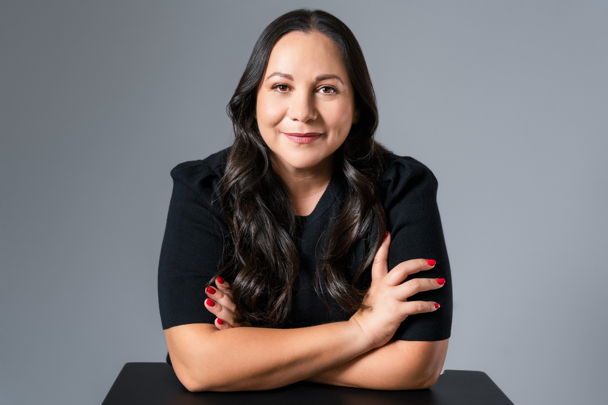 Personal branding image of woman in dark shirt at white table, entrepreneur lifestyle | Jessica Korff Studios Tucson, AZ