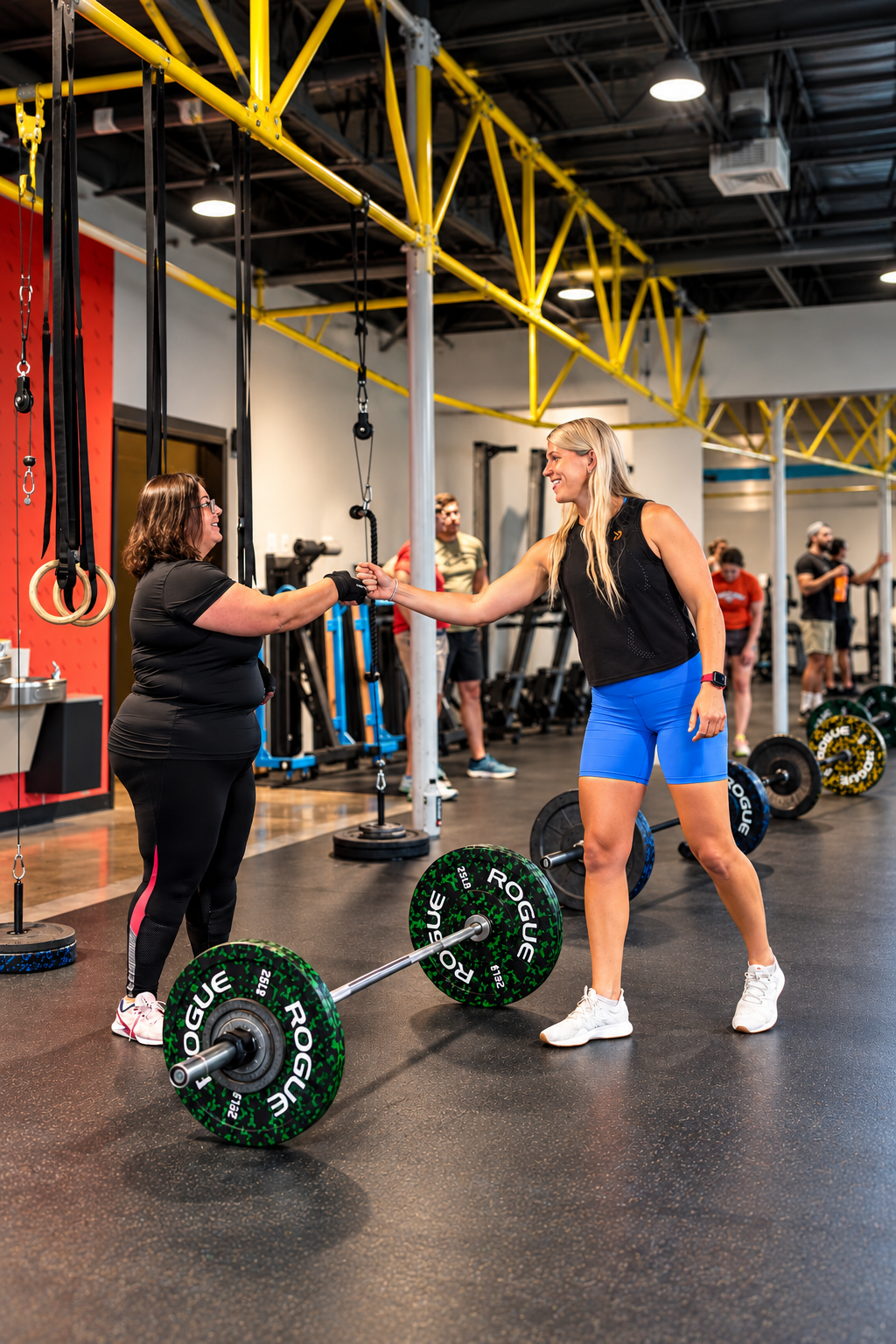 Iron Tribe Fitness athlete gets fist bump from Iron Tribe Coach